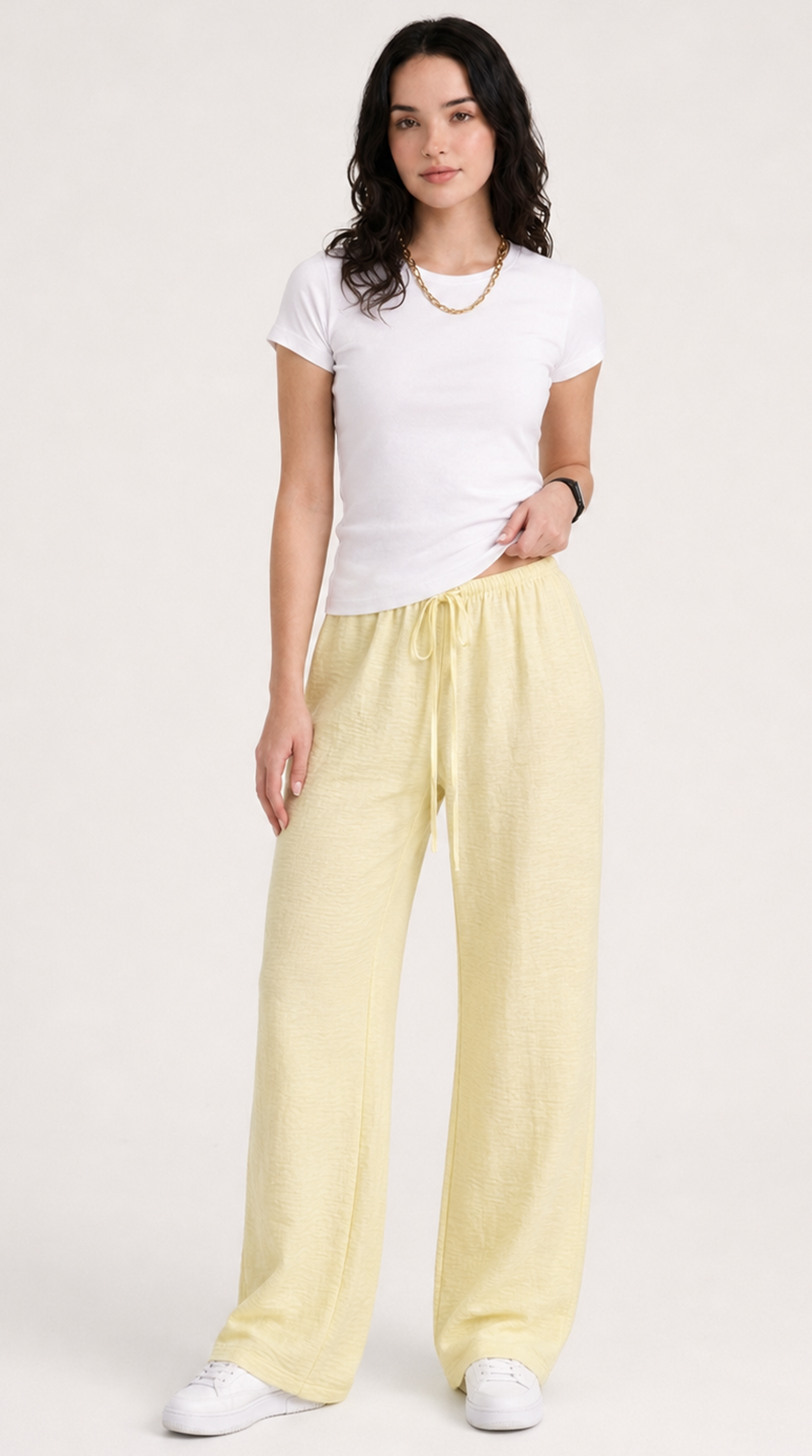 Woman wearing a white t-shirt and yellow pants on a white background, from Meleche Fashion USA or Meléche (short as (Mé))