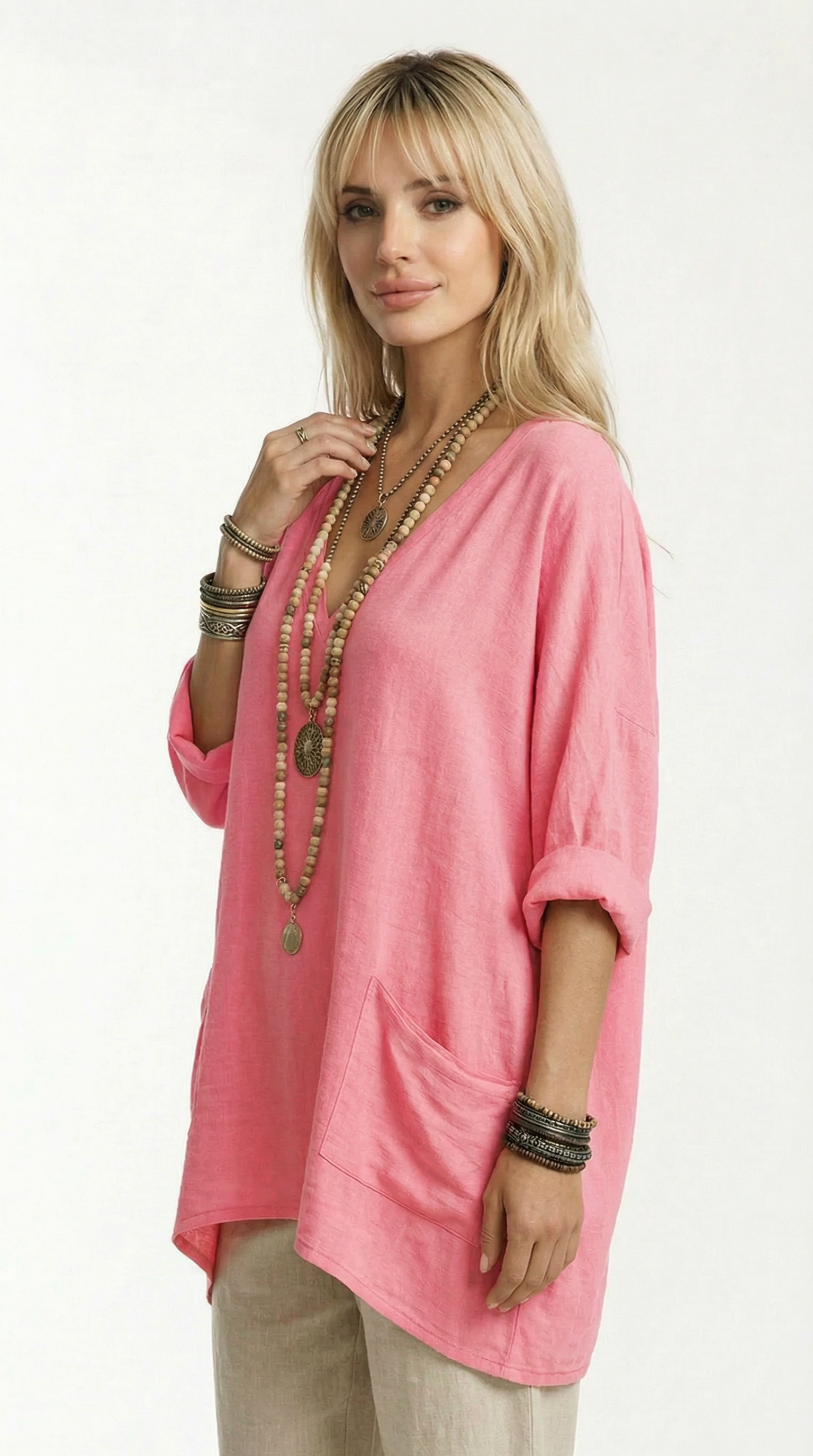 Woman wearing a pink oversized top with a plain background from Meleche or Meléche (short as (Mé))