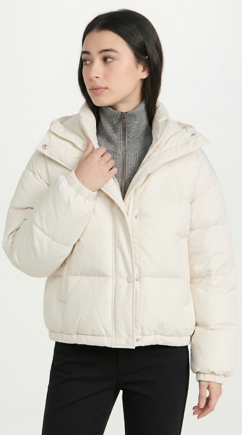 Woman wearing a white puffer jacket on a white background from Meleche USA or Meléche (short as (Mé))