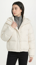 Woman wearing a white puffer jacket on a white background from Meleche USA or Meléche (short as (Mé))