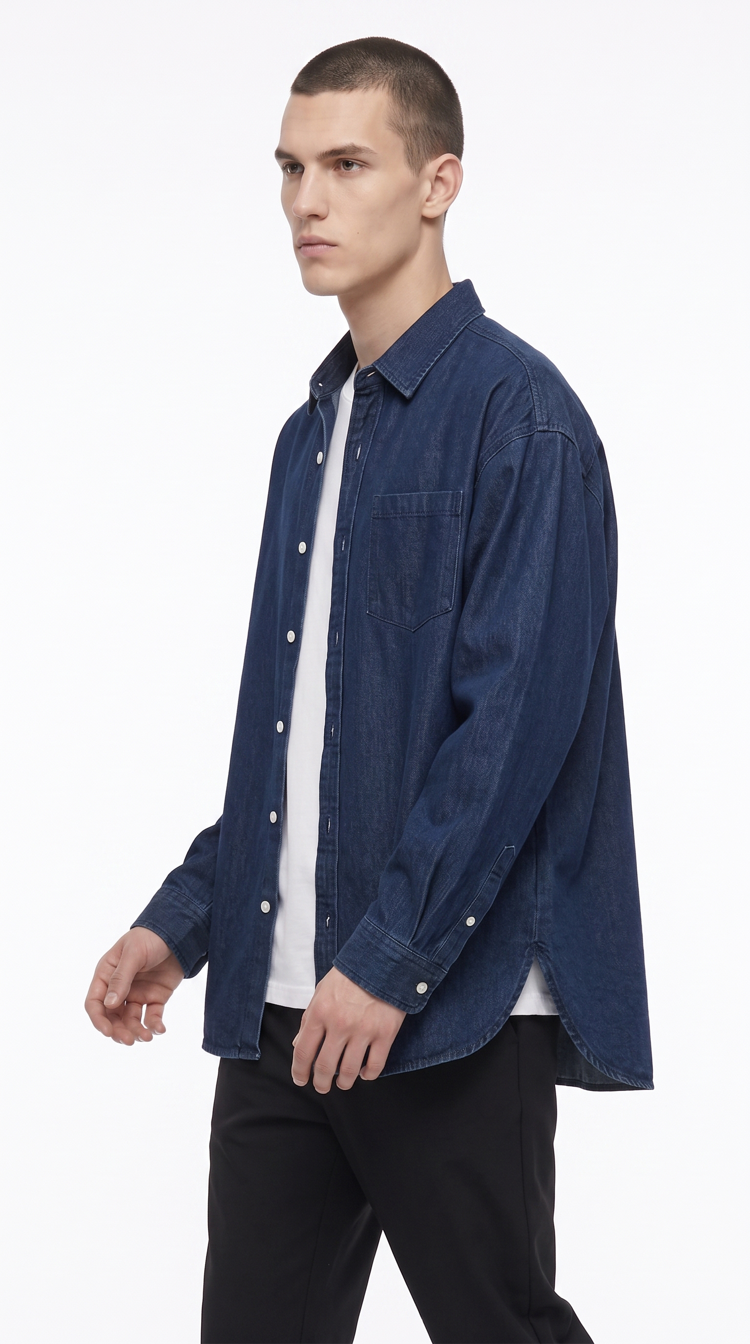 A man wearing a dark blue denim button-up shirt over a white t-shirt and black pants, photographed against a clean white studio background, from Meleche Fashion USA or Meléche (short as (Mé))