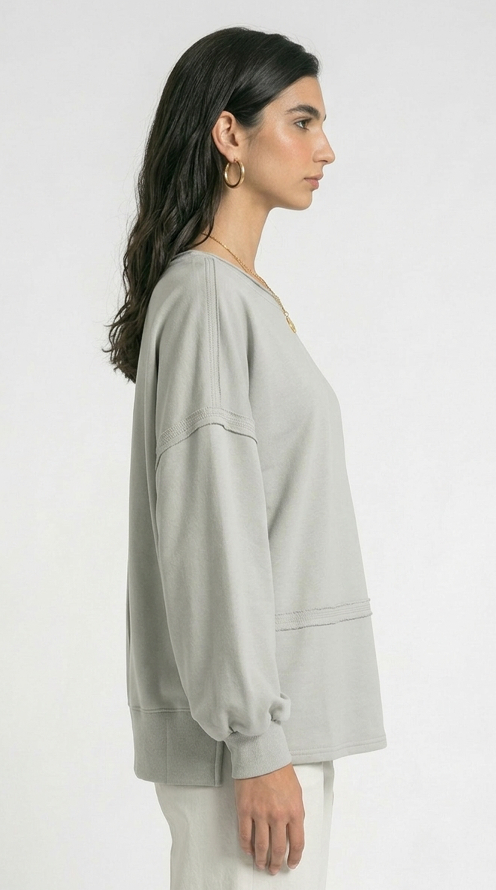 Woman wearing a pink oversized shirt with a white background