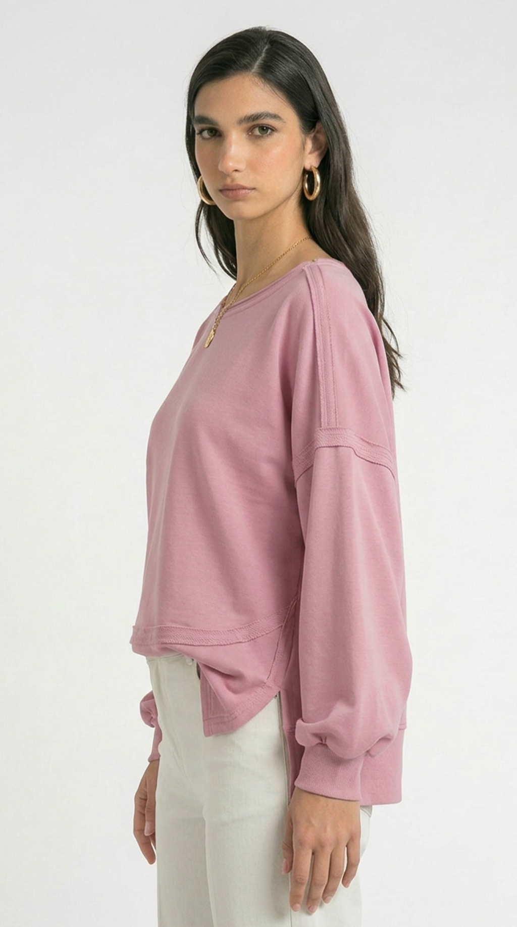 Woman wearing a pink tunic on a white background