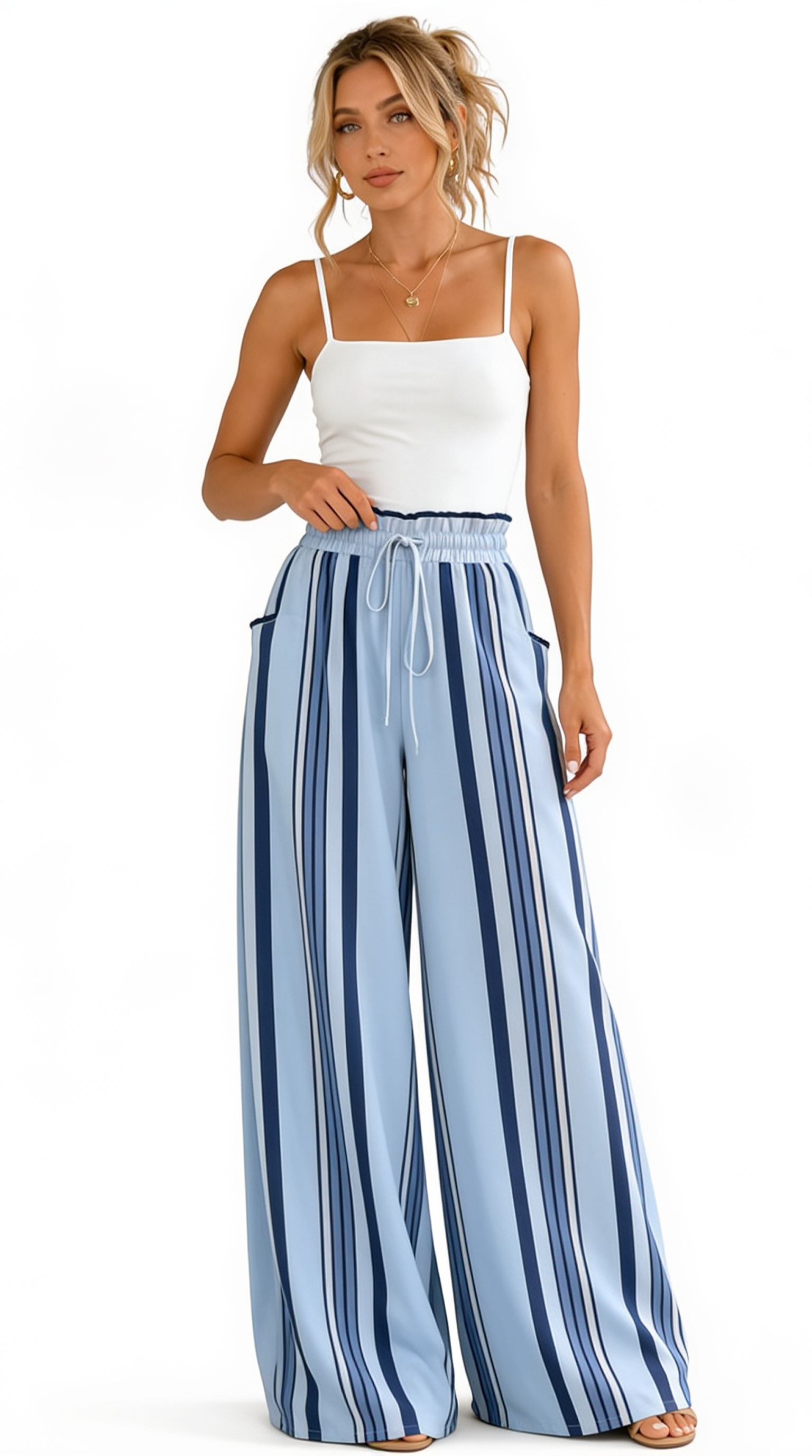 Woman wearing a white top and blue striped wide-leg pants on a white background