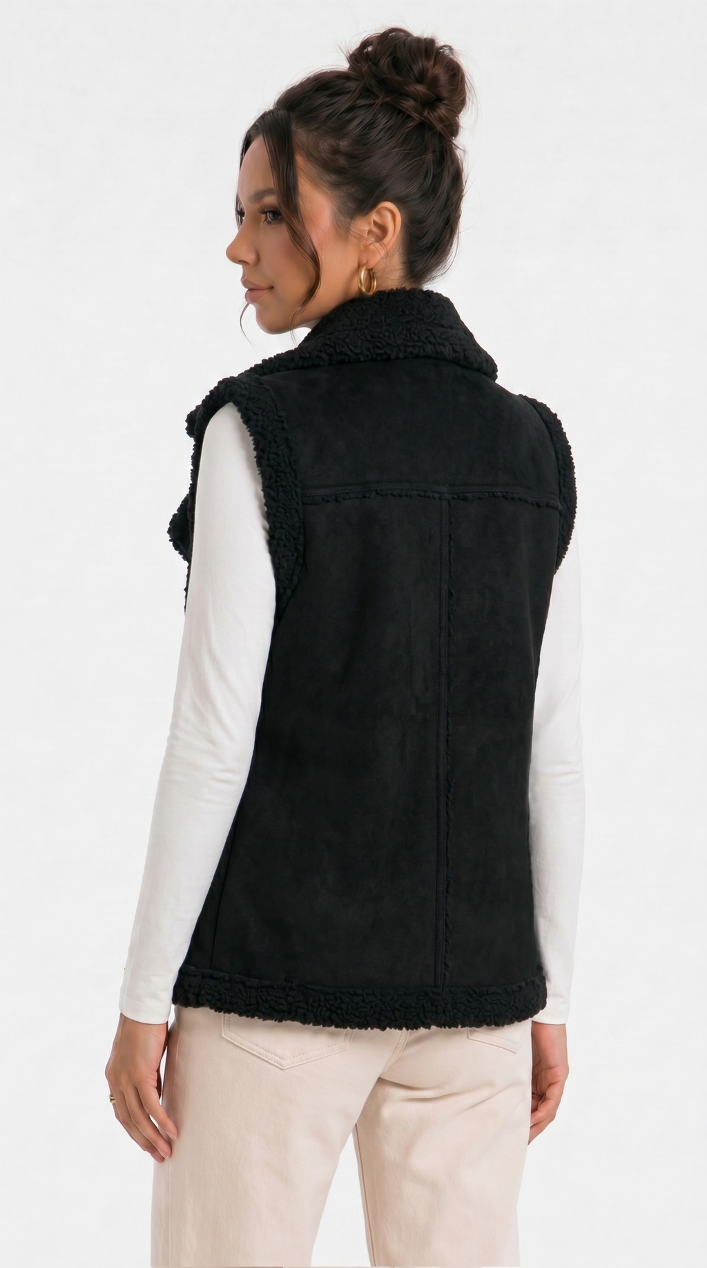 girl showing back side view wearing a black vest with a plain background from Meleche Fashion USA or Meléche (short as (Mé))