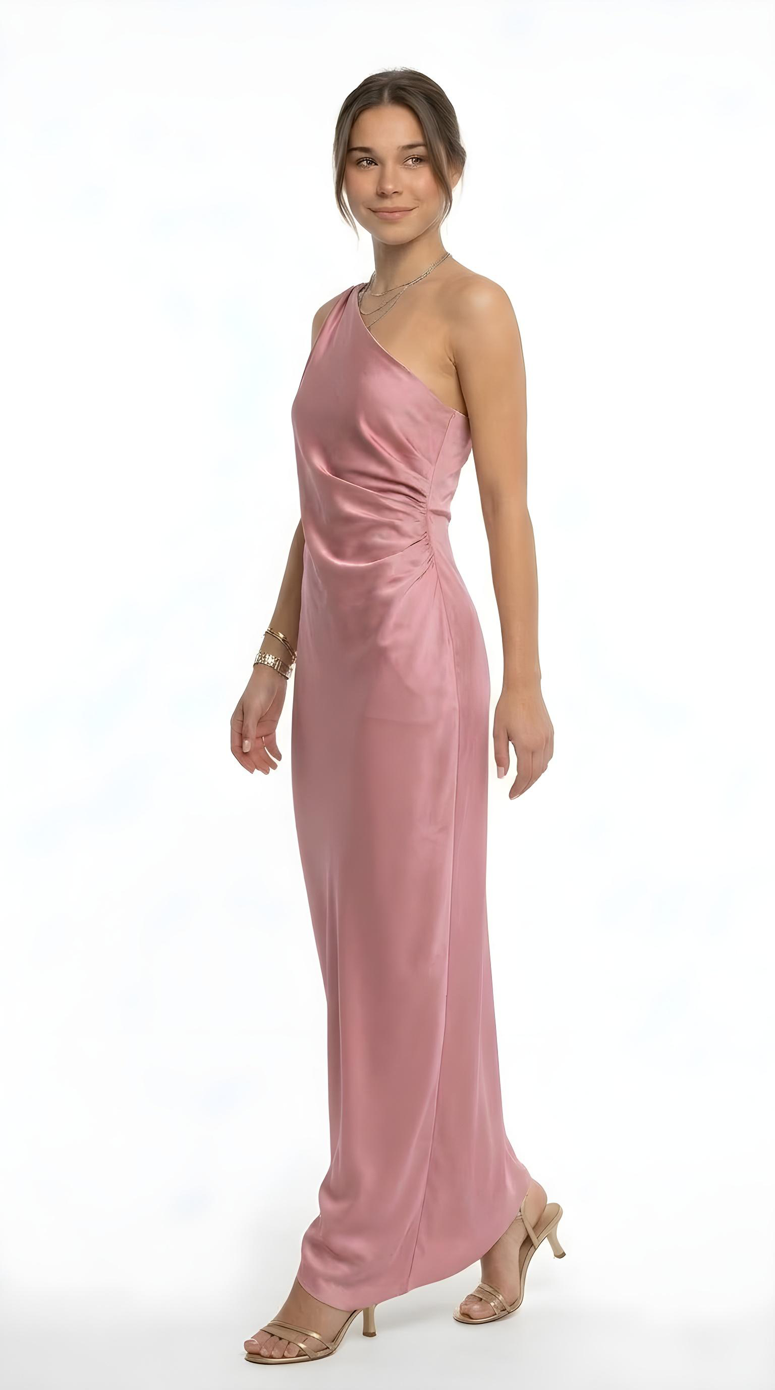 Woman wearing a beige long-sleeve top and white pants on a white background