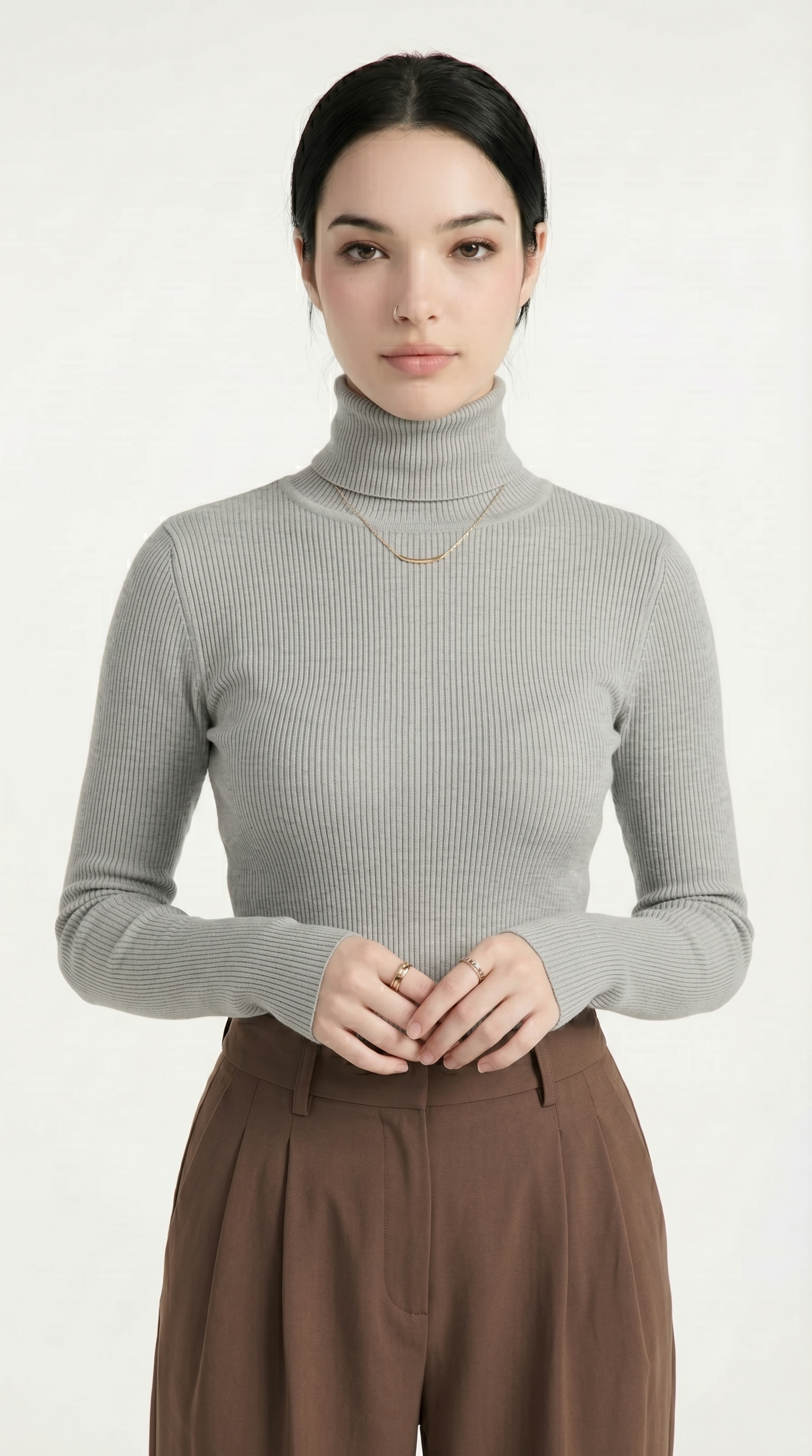 Person wearing a beige cable knit cardigan with button details on a white background from Meleche or Meléche USA (short as (Mé))