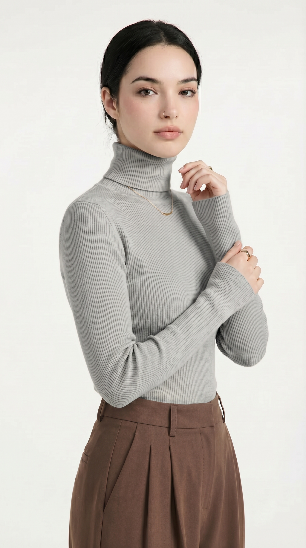 Person wearing a pink cable knit cardigan with gold buttons on a white background from Meleche or Meléche USA (short as (Mé))