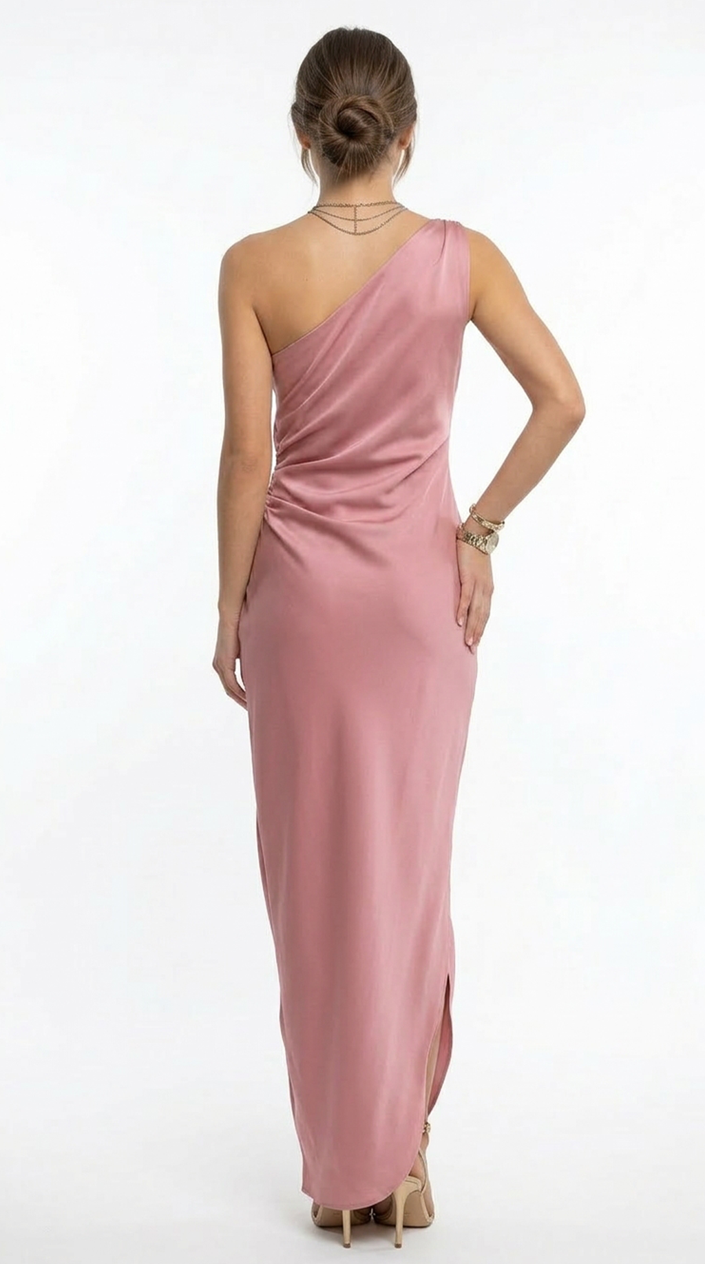 Woman wearing a one-shoulder pink gown on a white background