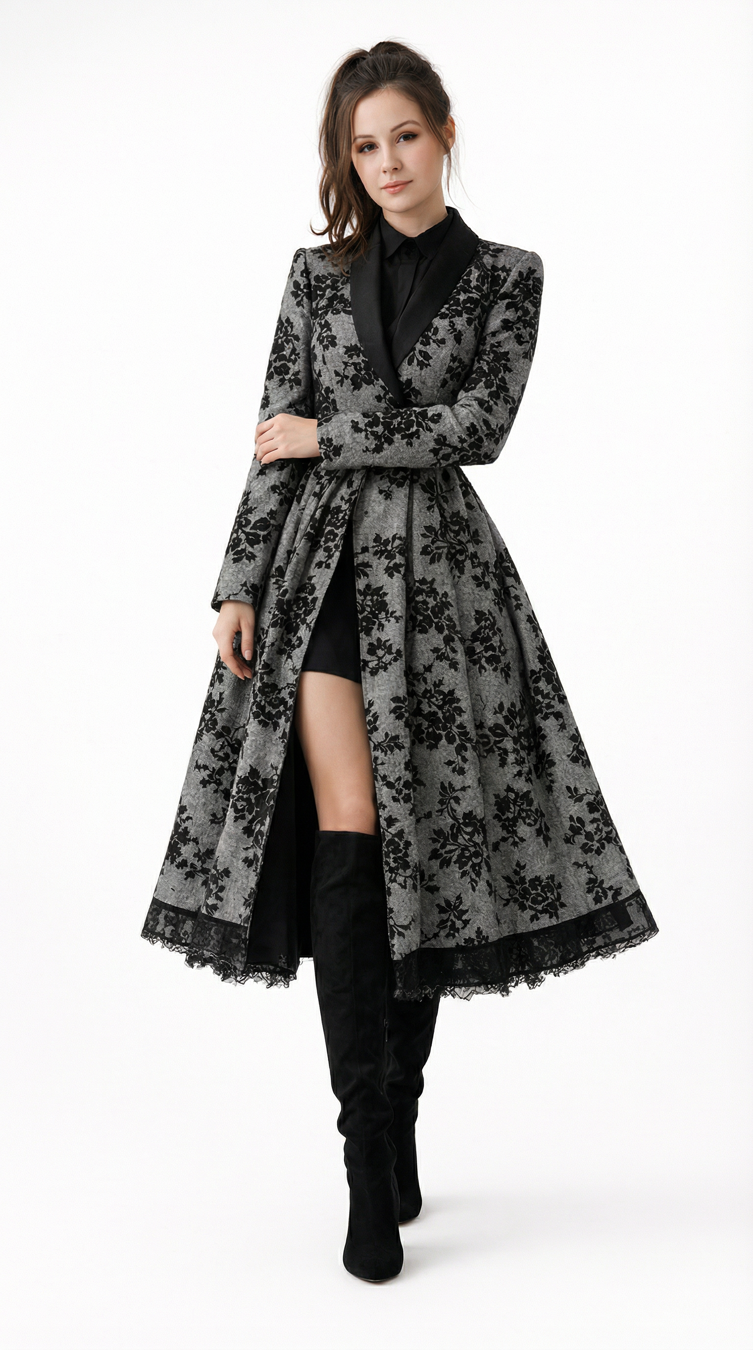 Mia Gray wearing a long black floral coat, Eden dress from Meleche or Meléche (short as (Mé)) on a white background