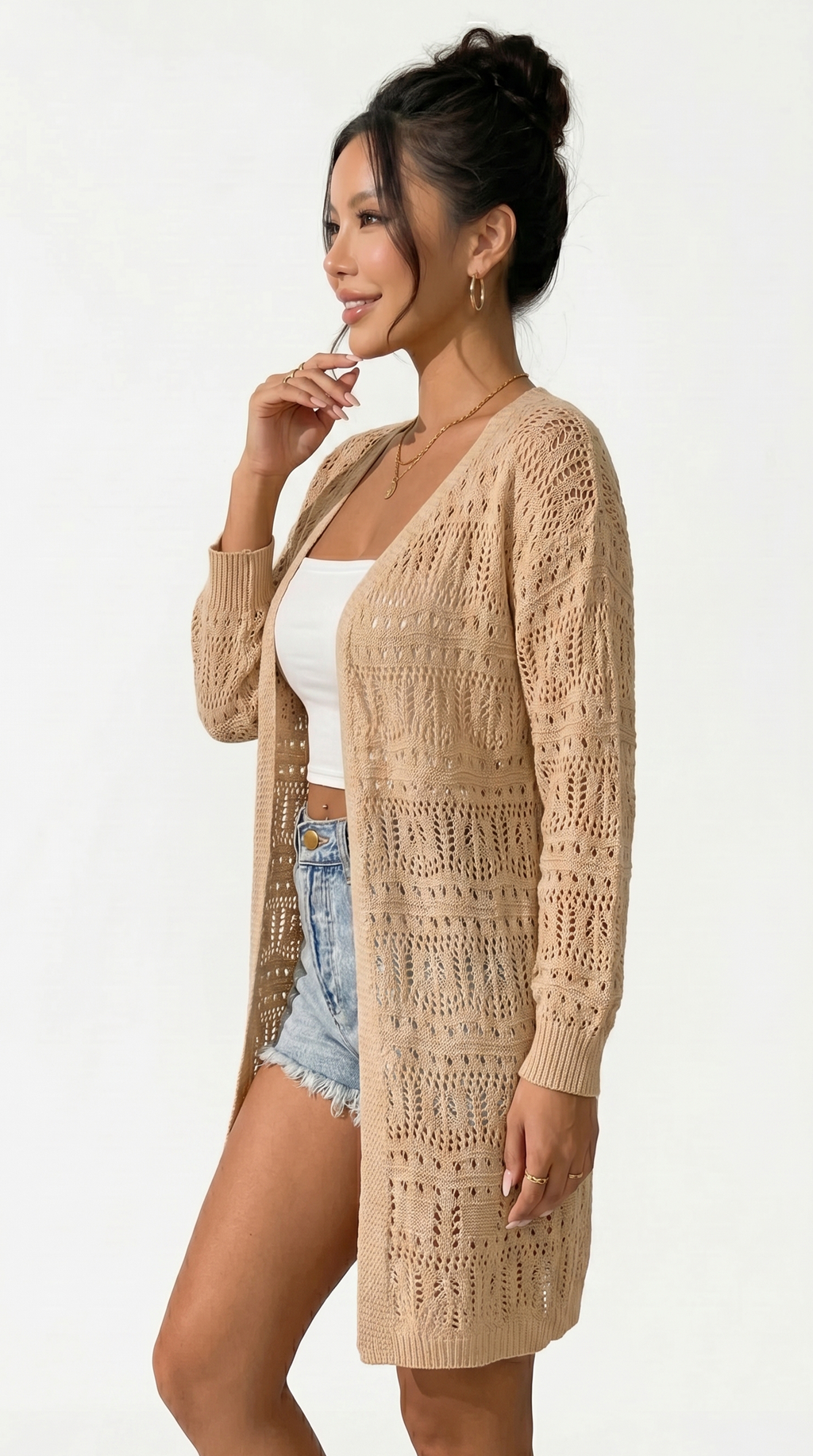 Woman wearing a beige crochet cardigan over a white top and denim shorts on a white background from Meleche or Meléche (short as (Mé))
