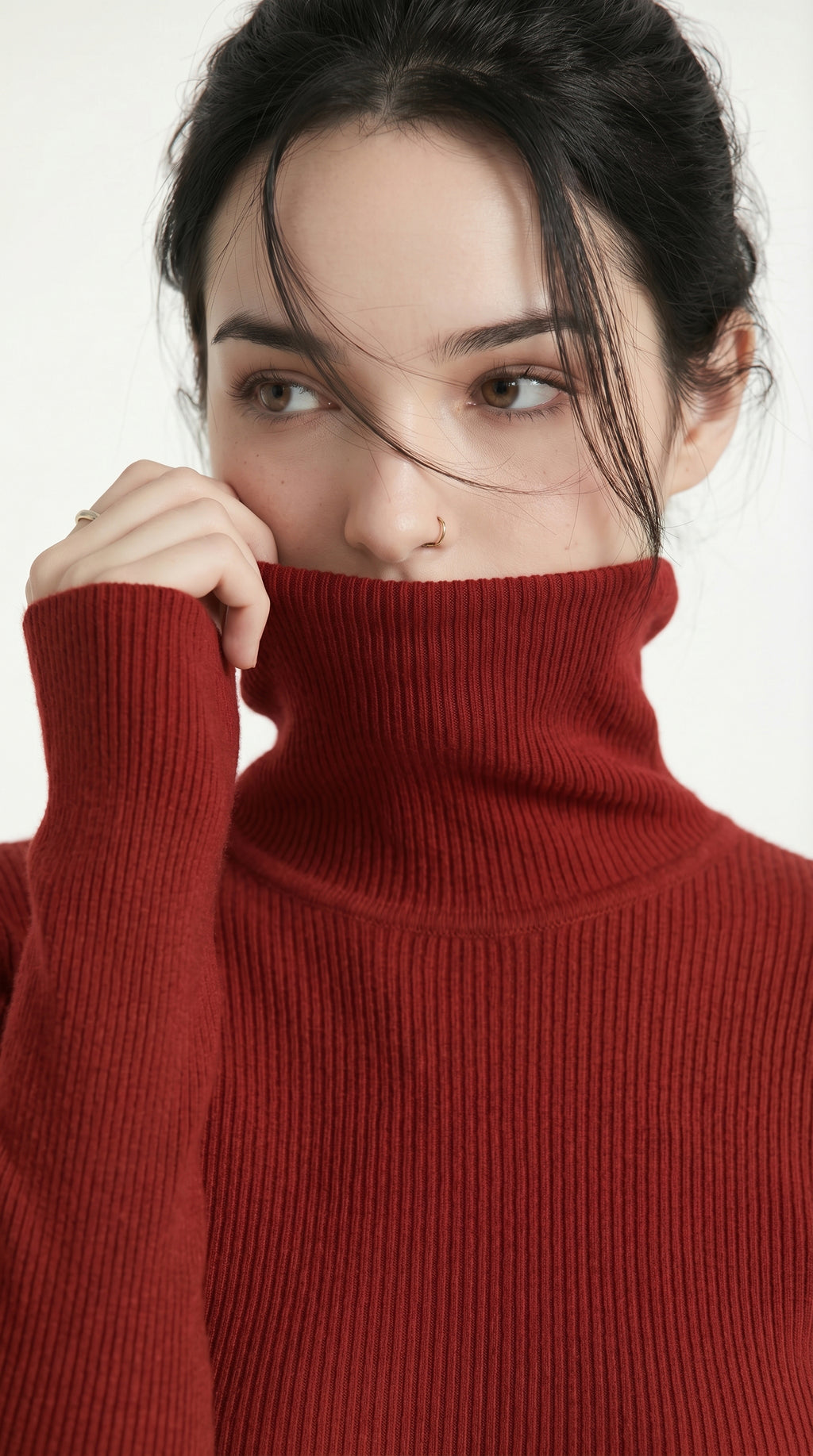 Woman wearing a red turtleneck sweater against a white background from Meleche USA or Meléche (short as (Mé))
