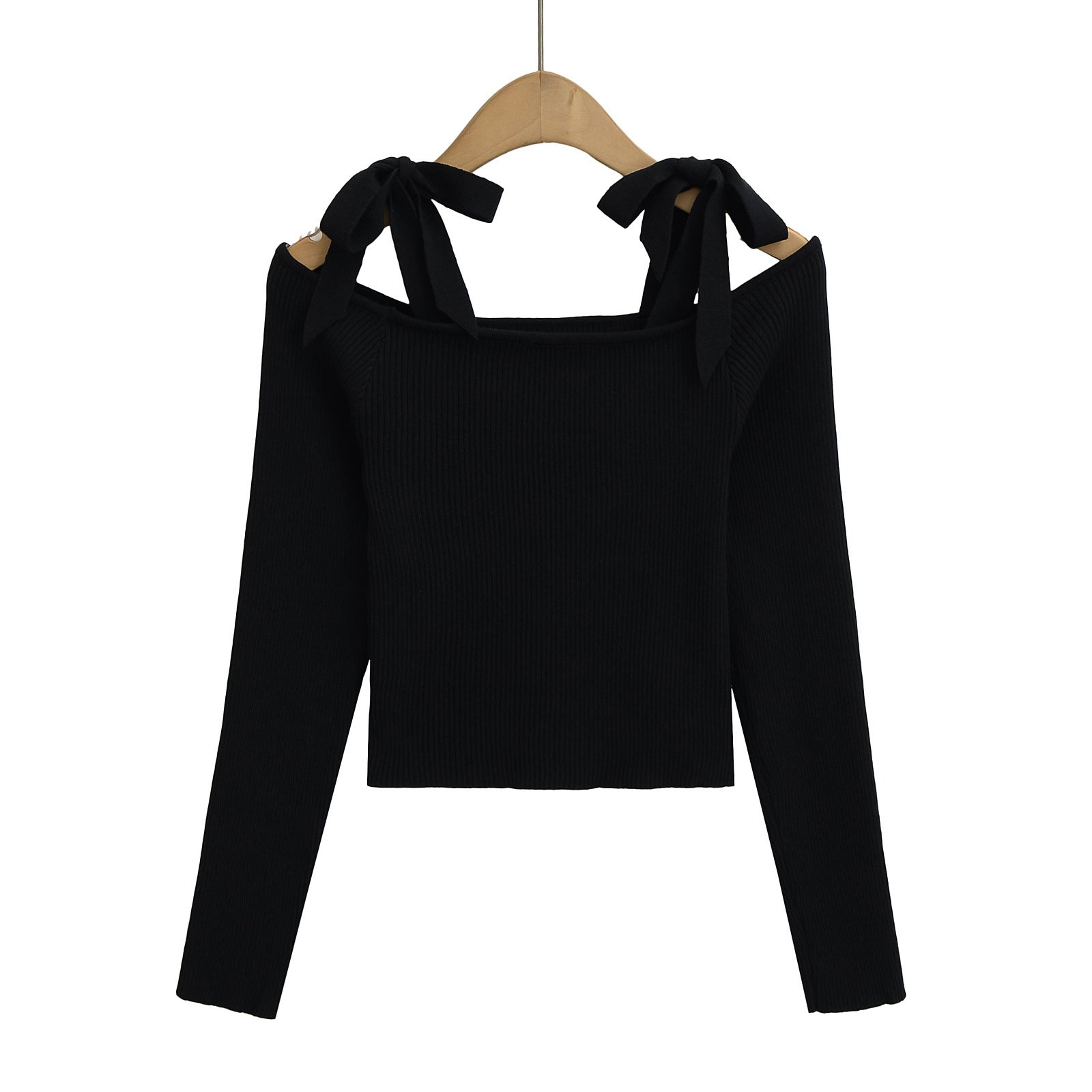 Black long-sleeve top with bow details on a hanger from Meleche or Meléche (short as (Mé))