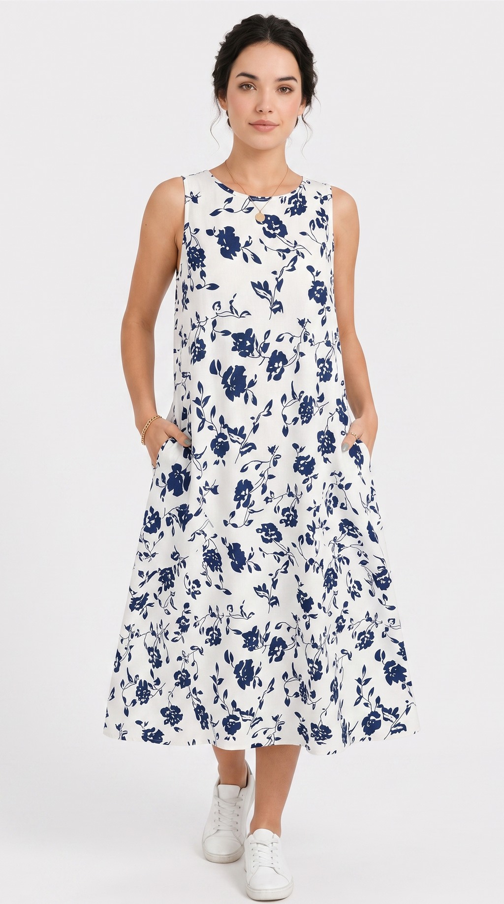 Woman wearing a white dress with blue floral pattern on a white background