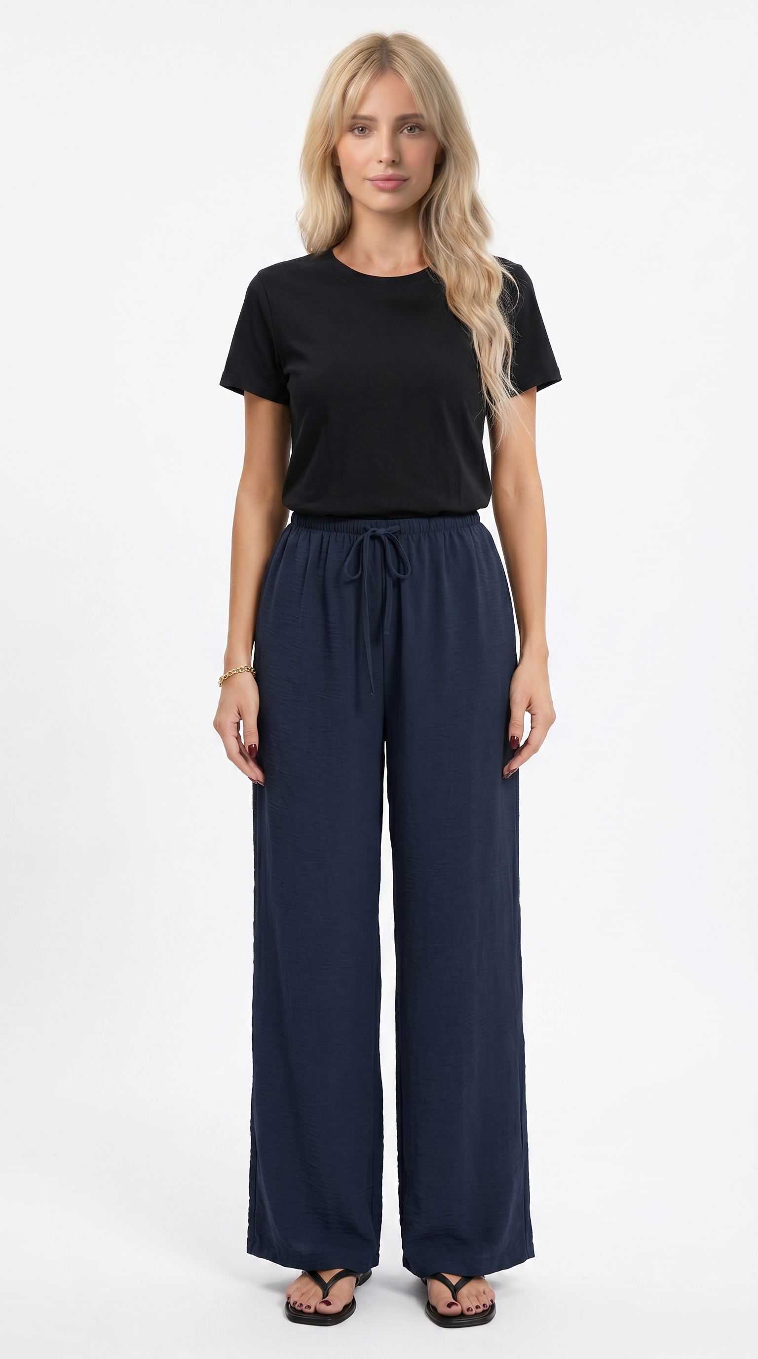 Woman wearing a black top and navy wide-leg pants on a white background, sexy loss pants from Meleche Fashion USA or Meléche (short as (Mé))