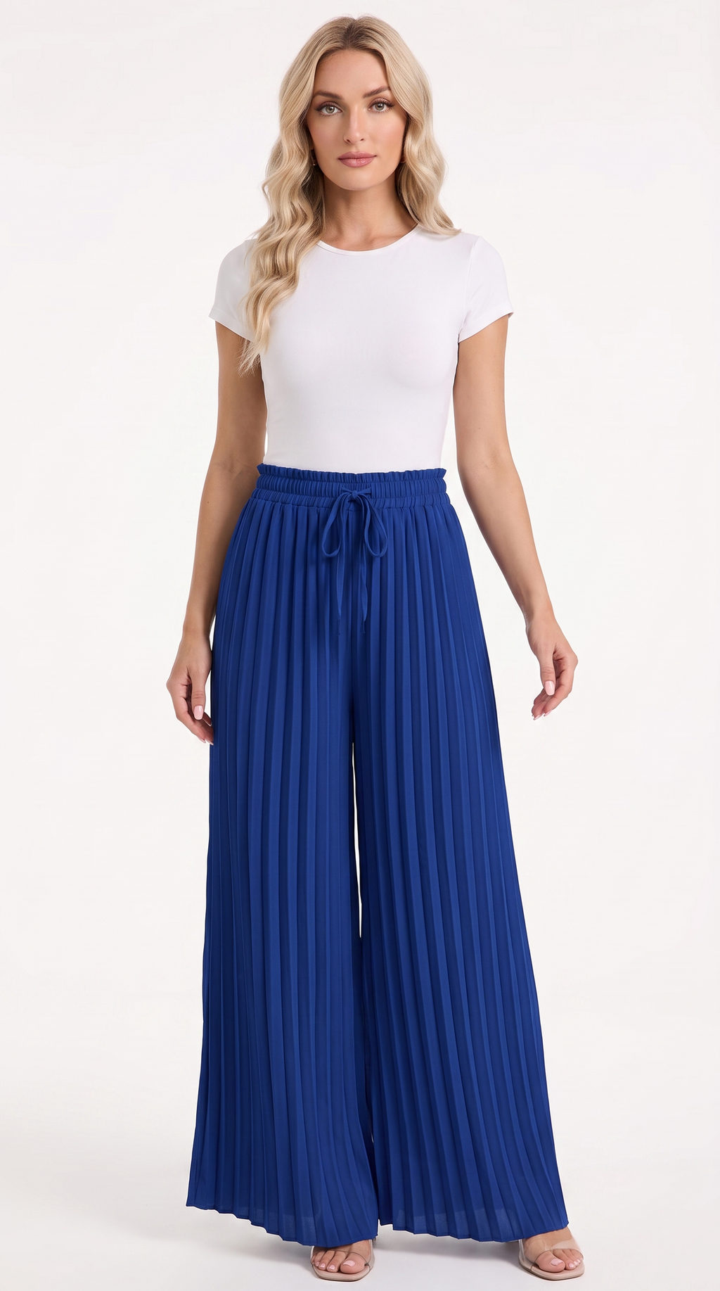 A woman modeling a white short-sleeve crewneck top and high-waisted royal blue pleated wide-leg pants with a drawstring waist, standing against a plain white studio background, from Meleche Fashion USA or Meléche (short as (Mé))