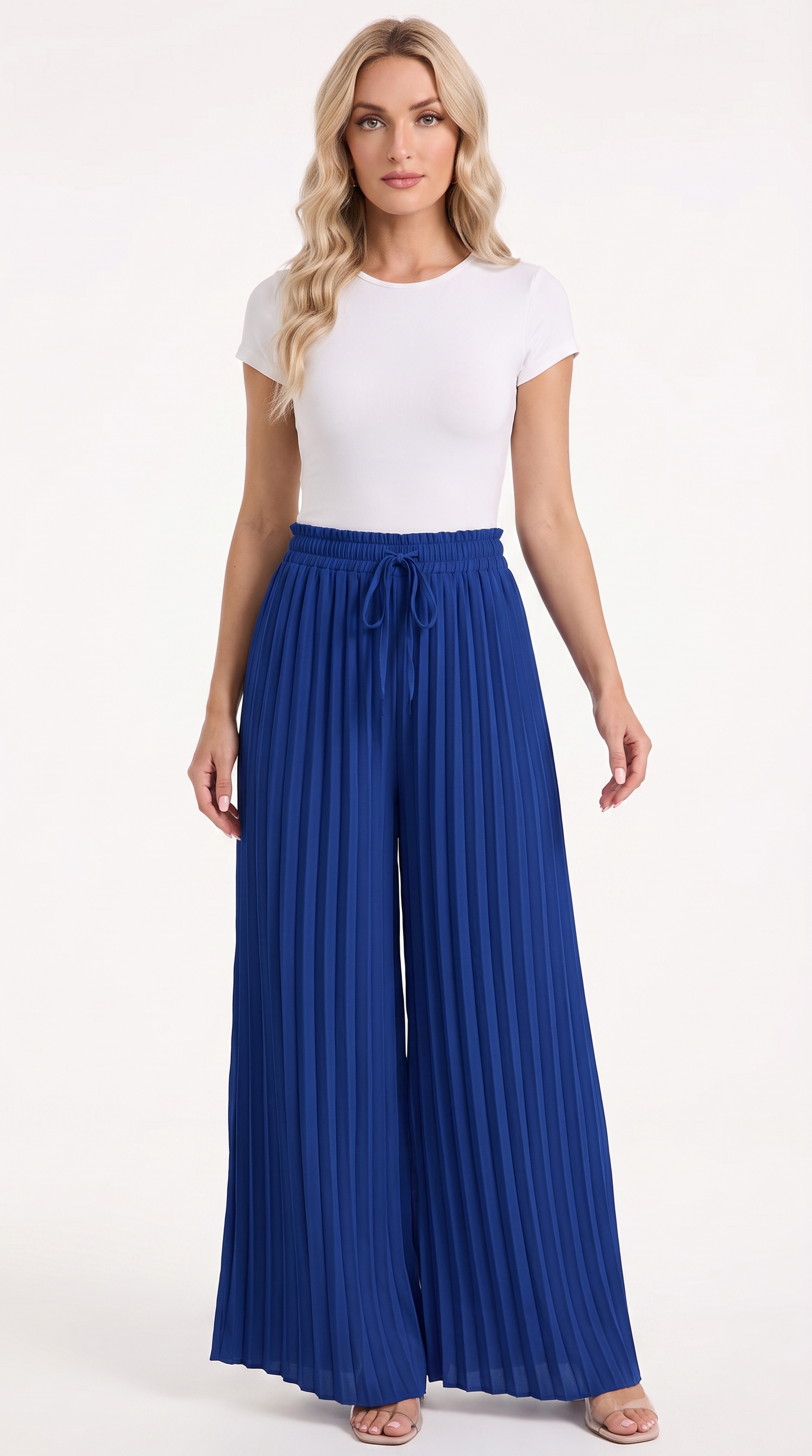 A woman modeling a white short-sleeve crewneck top and high-waisted royal blue pleated wide-leg pants with a drawstring waist, standing against a plain white studio background, from Meleche Fashion USA or Meléche (short as (Mé))
