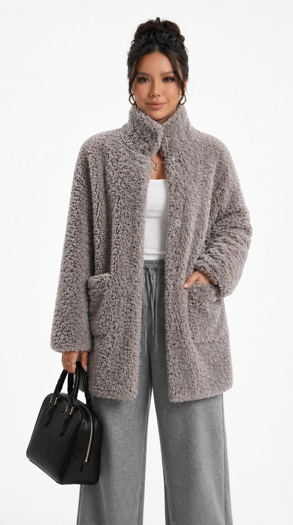 Woman wearing a fluffy beige coat with gray pants and holding a black handbag on a white background from Meleche Fashion USA or Meléche (short as (Mé))