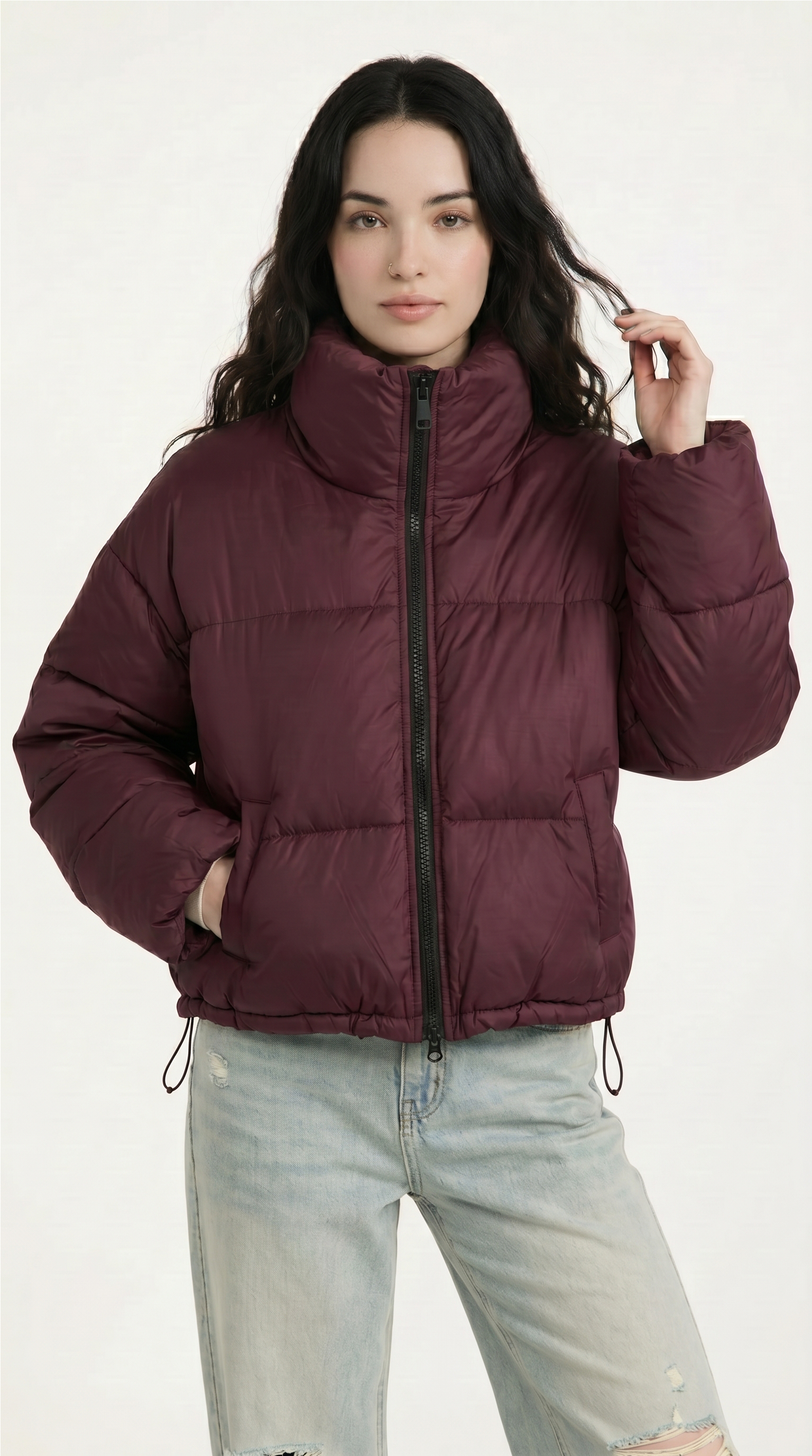 Woman wearing a maroon puffer jacket on a white background from Meleche USA or Meléche (short as (Mé))