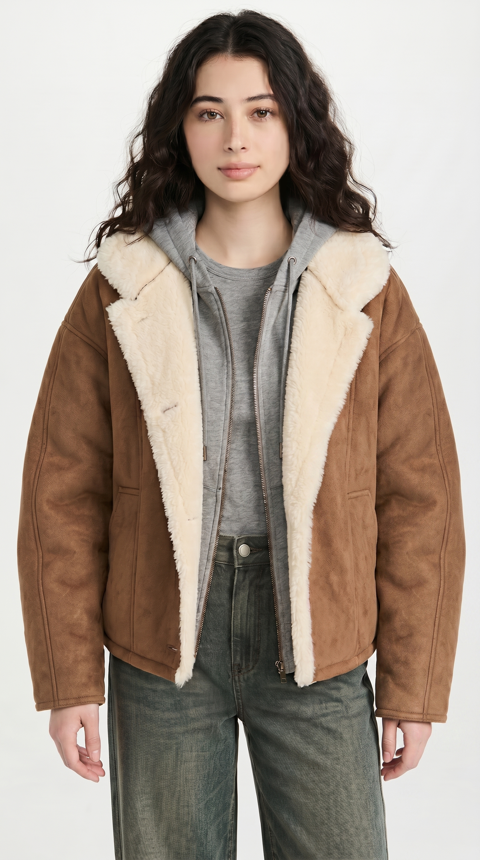 Woman wearing a brown leather jacket with white fur lining on a white background from Meleche or Meléche USA (short as (Mé))