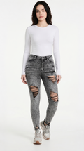 Woman wearing a white long-sleeve top and gray ripped jeans on a white background,  slim fit Skinny jeans from Meleche Fashion USA or Meléche (short as (Mé))