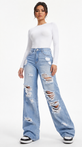 Person wearing light blue ripped jeans and a white top on a white background, Wide-leg jeans from Meleche Fashion USA or Meléche (short as (Mé))