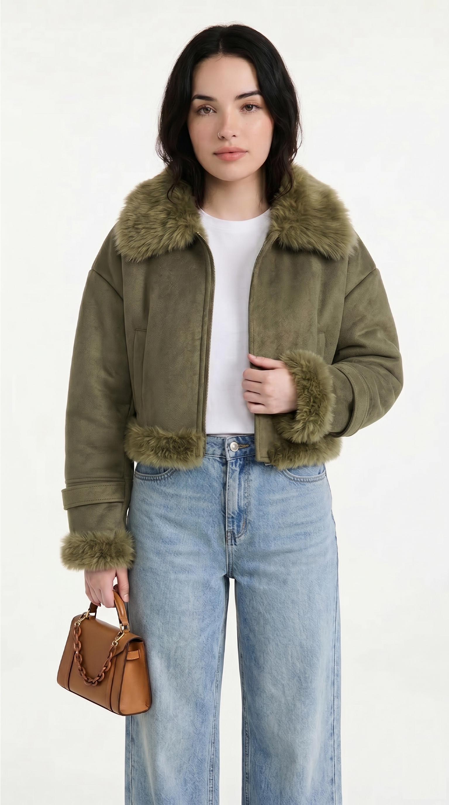 Woman wearing an olive green jacket with fur trim, white shirt, and blue jeans, holding a brown handbag on a white background from Meleche USA or Meléche (short as (Mé))