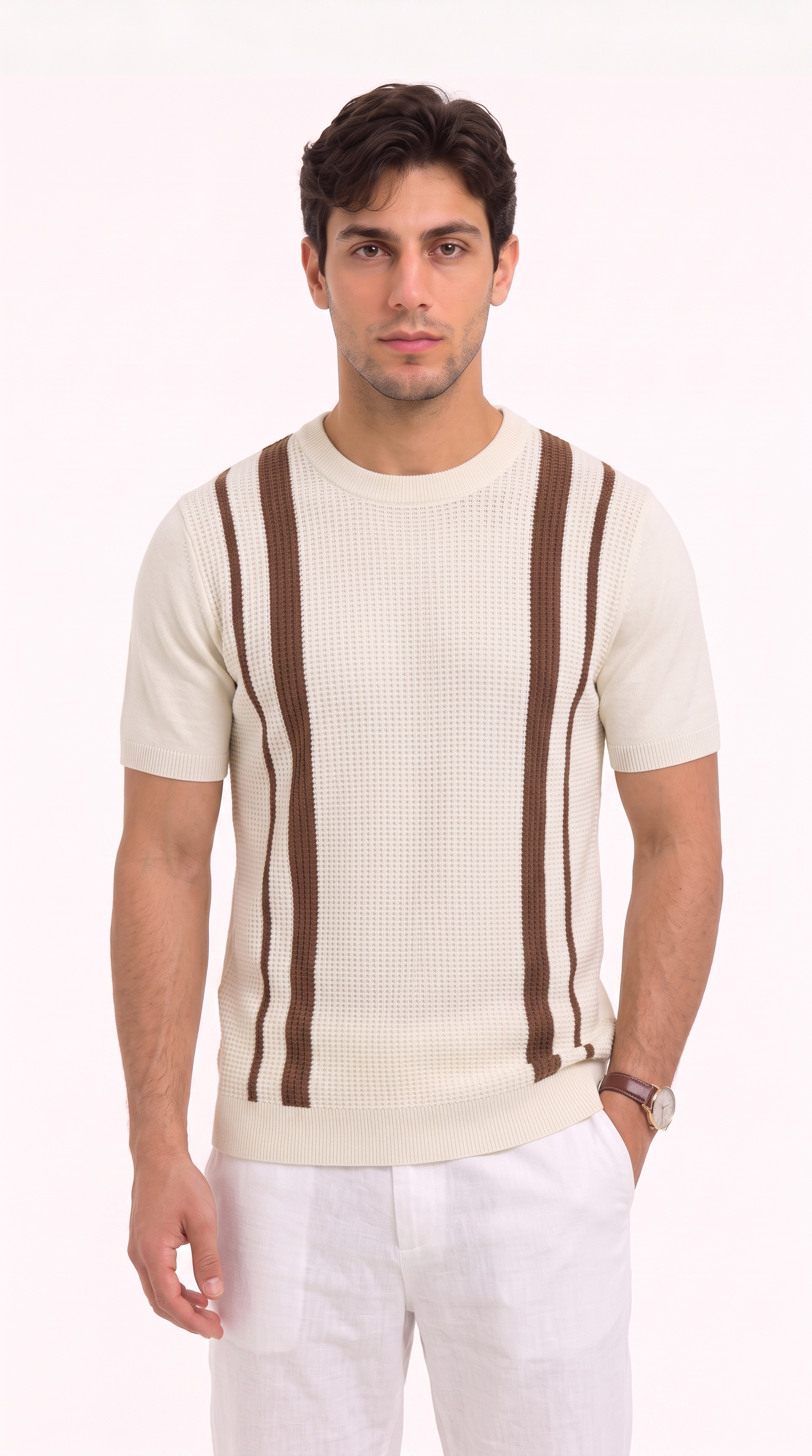 A man wearing a cream-colored short-sleeve knit sweater with brown vertical stripe details, paired with white trousers, standing against a plain white studio background, from Meleche Fashion USA or Meléche (short as (Mé))