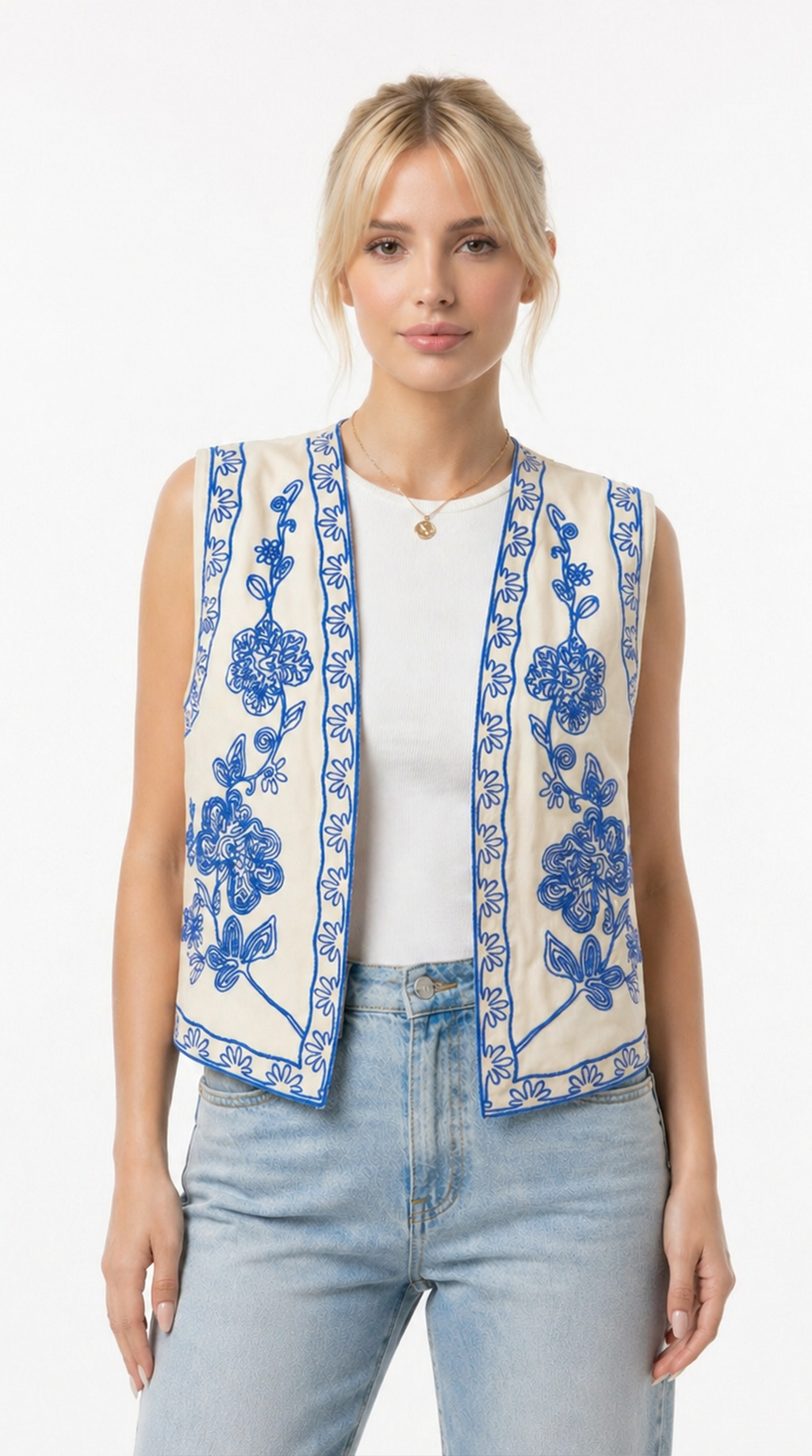 Woman wearing a sleeveless embroidered vest over a white shirt and jeans on a white background from Meleche Fashion USA or Meléche (short as (Mé))