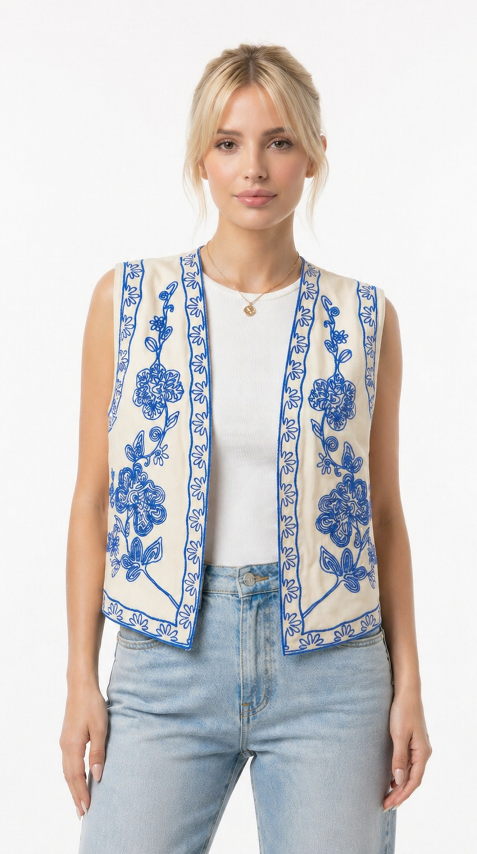 Woman wearing a sleeveless embroidered vest over a white shirt and jeans on a white background from Meleche Fashion USA or Meléche (short as (Mé))
