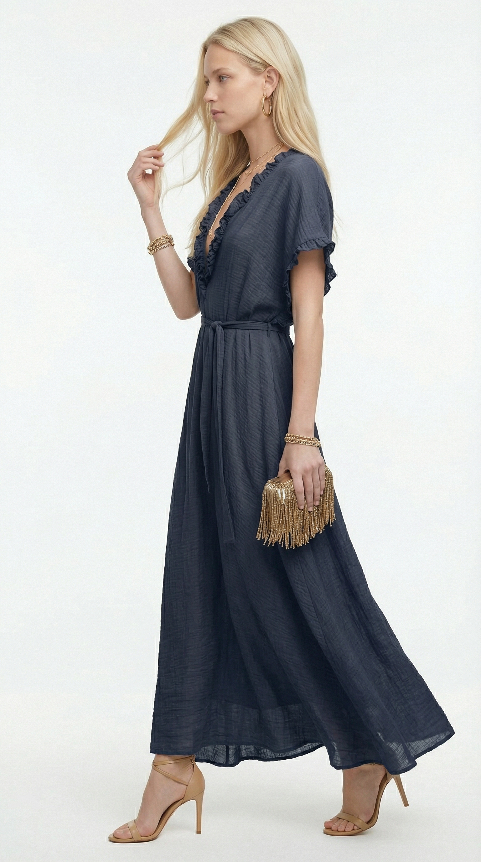 Woman wearing a dark blue dress with a white background