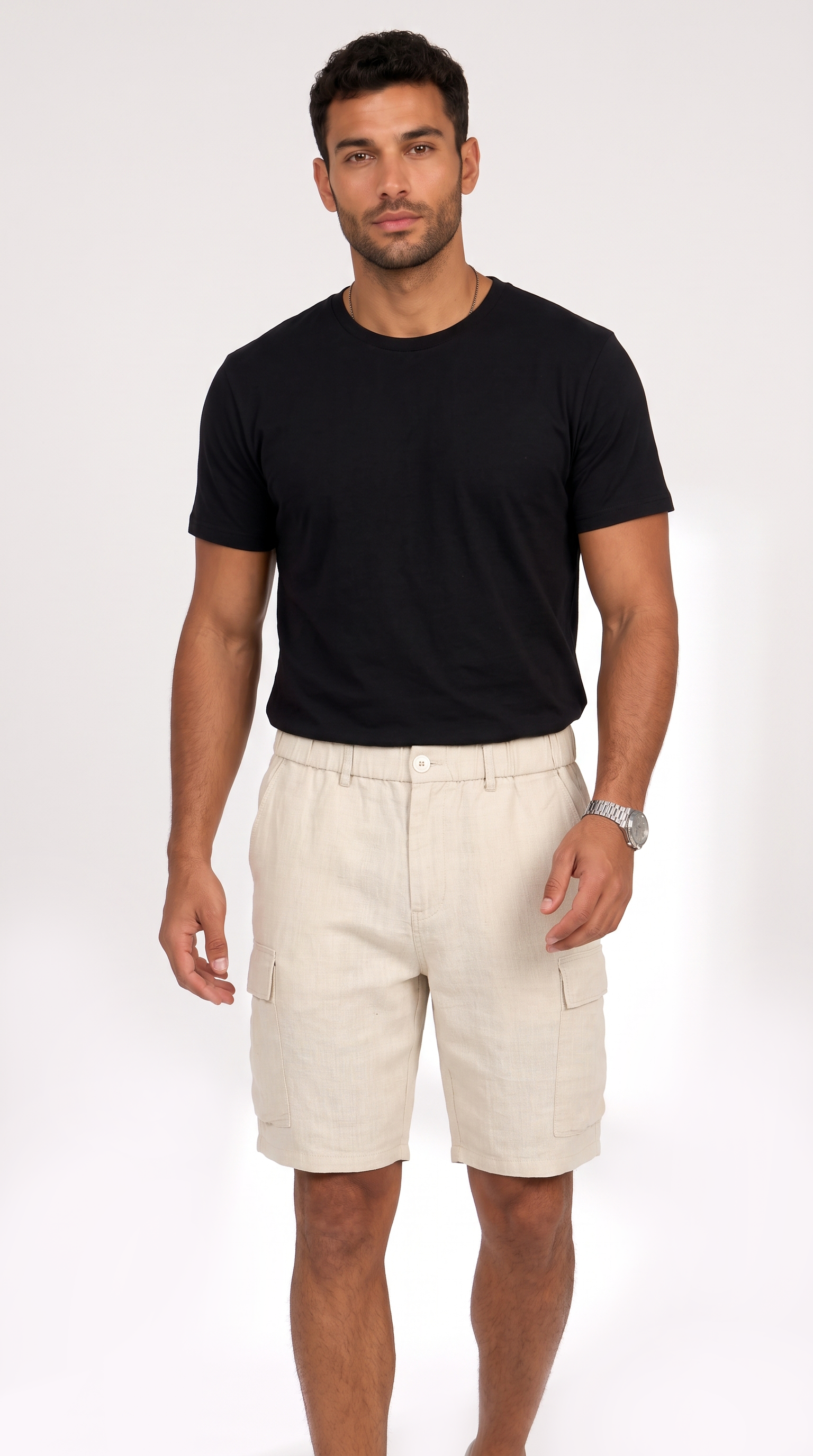 A man modeling a black short-sleeve crewneck t-shirt and light beige cargo shorts against a plain white studio background, from Meleche Fashion USA or Meléche (short as (Mé))