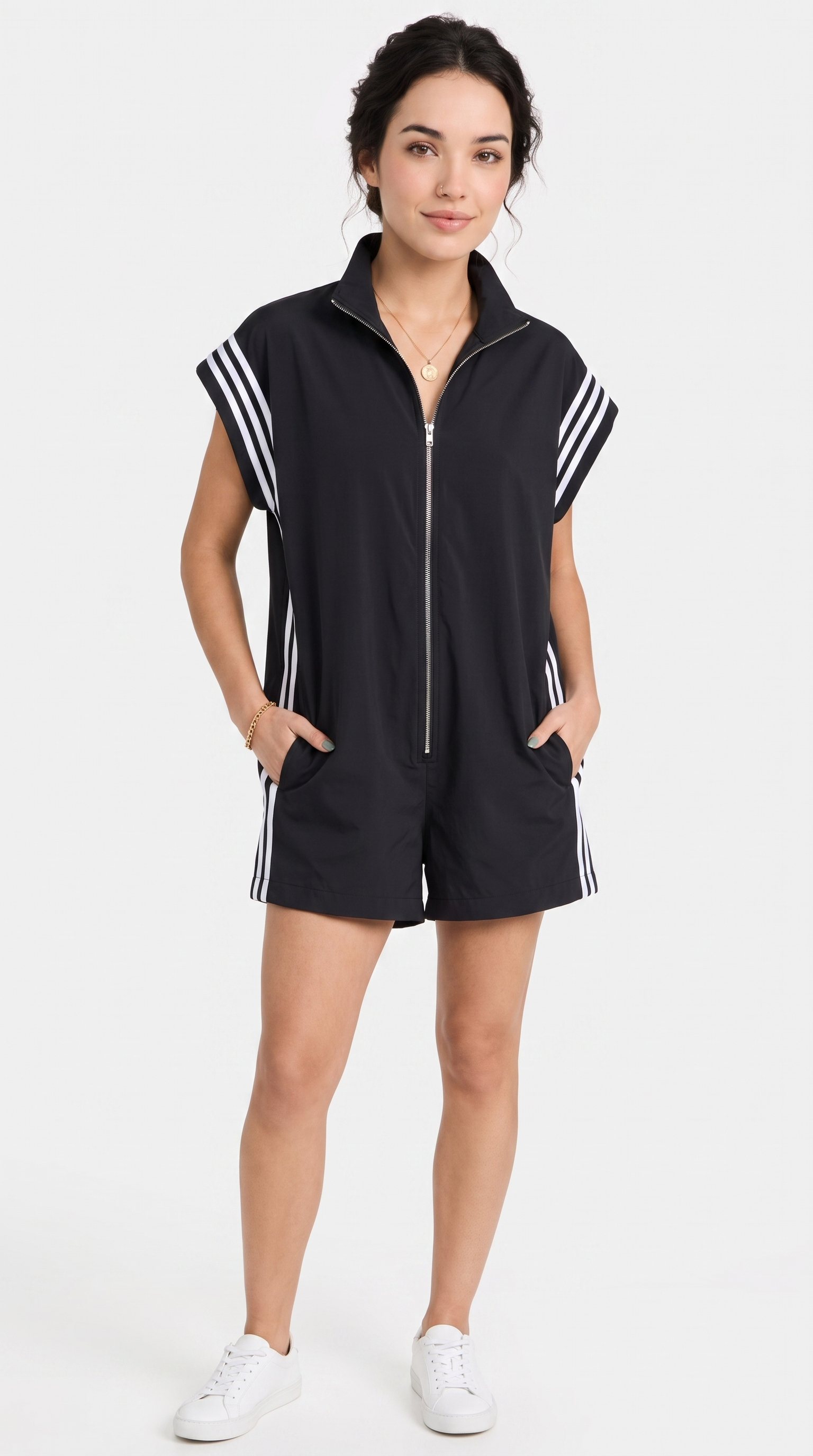 Woman wearing a black sleeveless zip-up romper with white stripes on a white background, from Meleche Fashion USA or Meléche (short as (Mé))