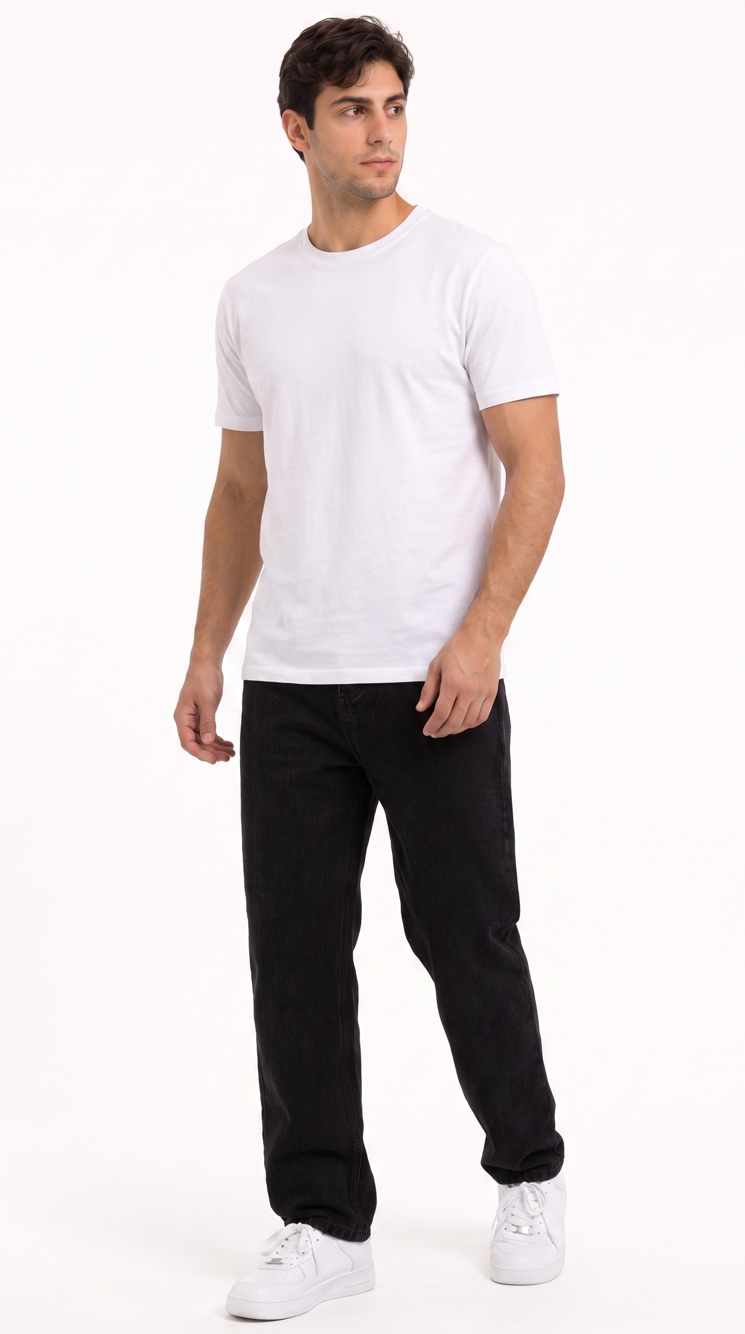 A man modeling a plain white short-sleeve crewneck t-shirt, paired with black jeans and white sneakers, standing against a solid white studio background, from Meleche Fashion USA or Meléche (short as (Mé))