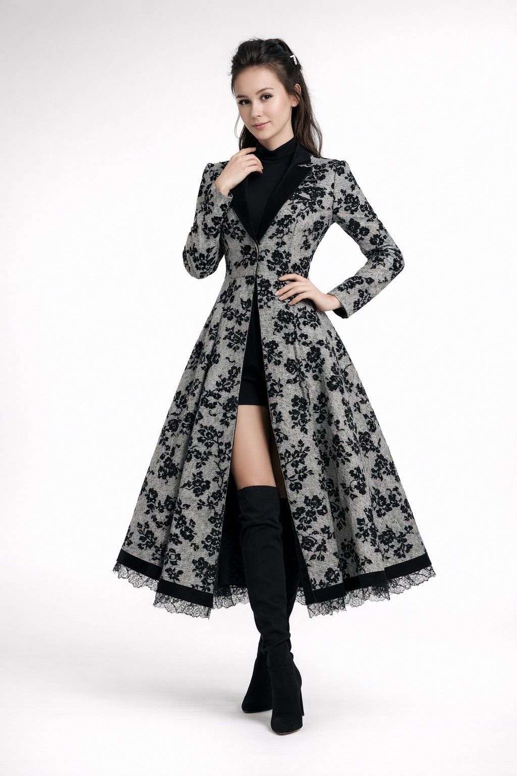 Mia Gray wearing a long black and white floral coat Eden dress from Meleche or Meléche (short as (Mé)) on a white background