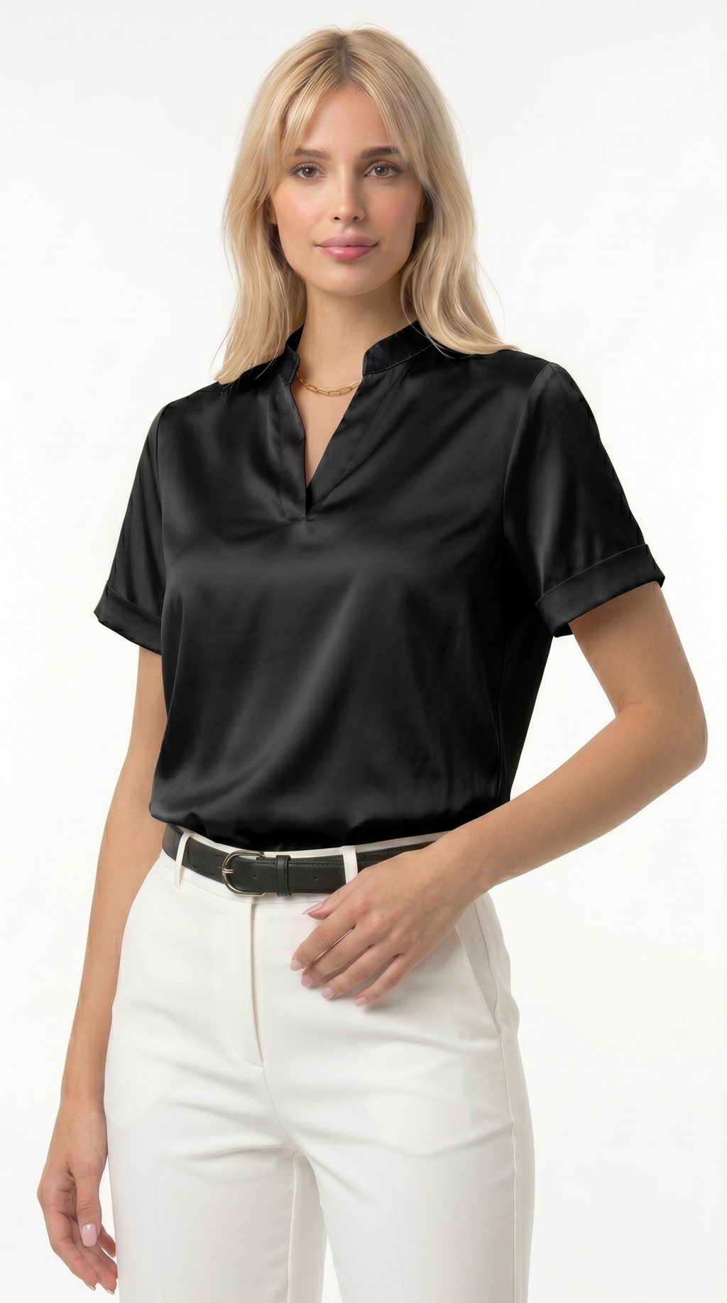 Woman wearing a black satin blouse and white pants on a white background