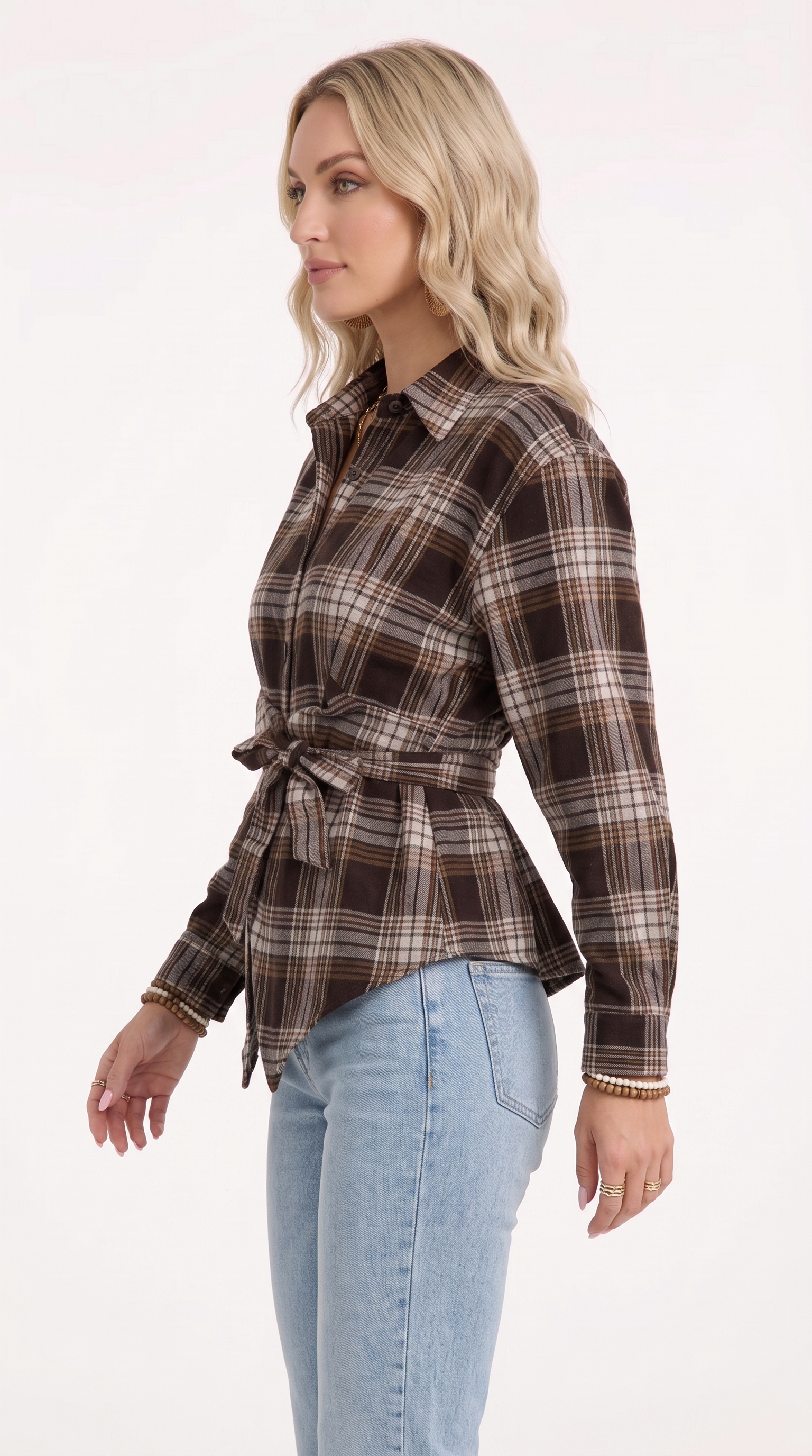 A woman wearing a brown and beige plaid long-sleeve shirt with a tie waist, paired with light blue jeans, shown from a side profile against a plain white background, from Meleche Fashion USA or Meléche (short as (Mé))