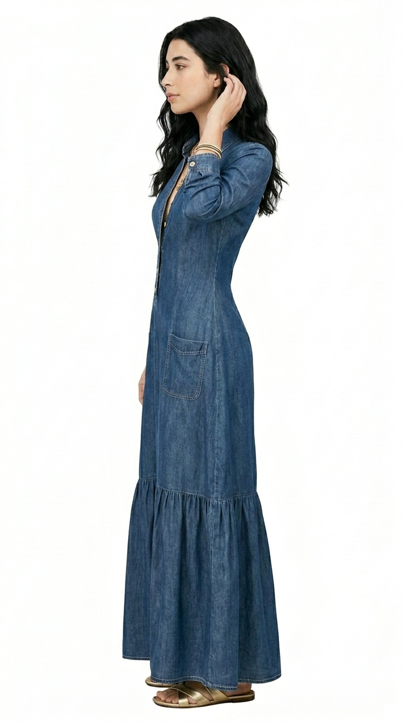 Woman wearing a dark gray tiered dress on a white background