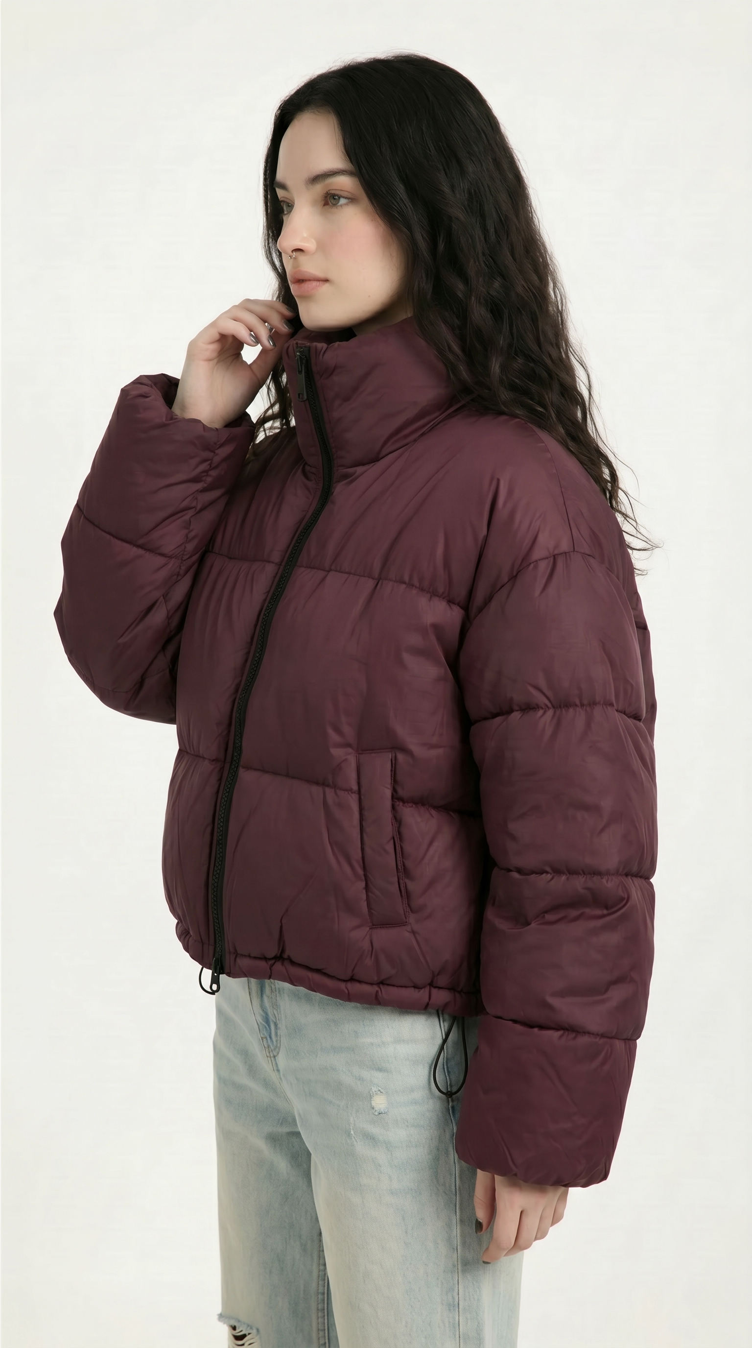 Woman wearing a maroon puffer jacket on a white background from Meleche or Meléche USA (short as (Mé))