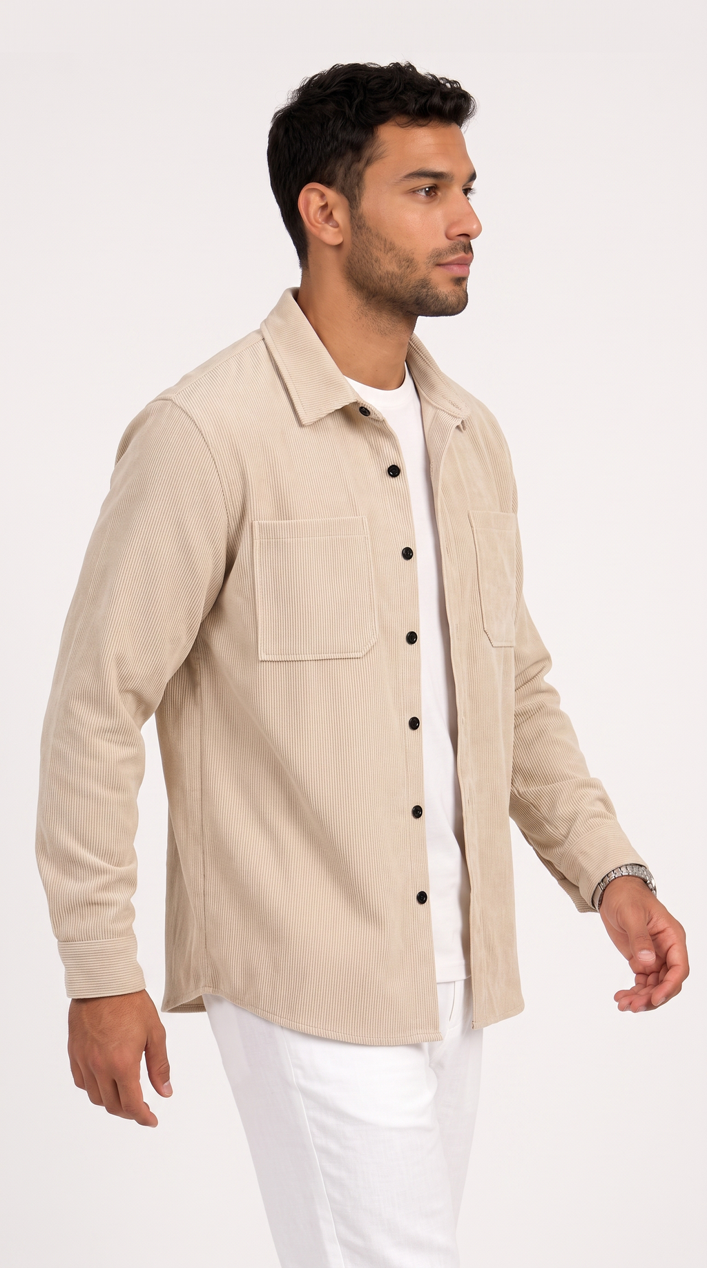 A man wearing a light beige button-up overshirt over a white t-shirt and white pants, photographed against a plain white studio background, from Meleche Fashion USA or Meléche (short as (Mé))