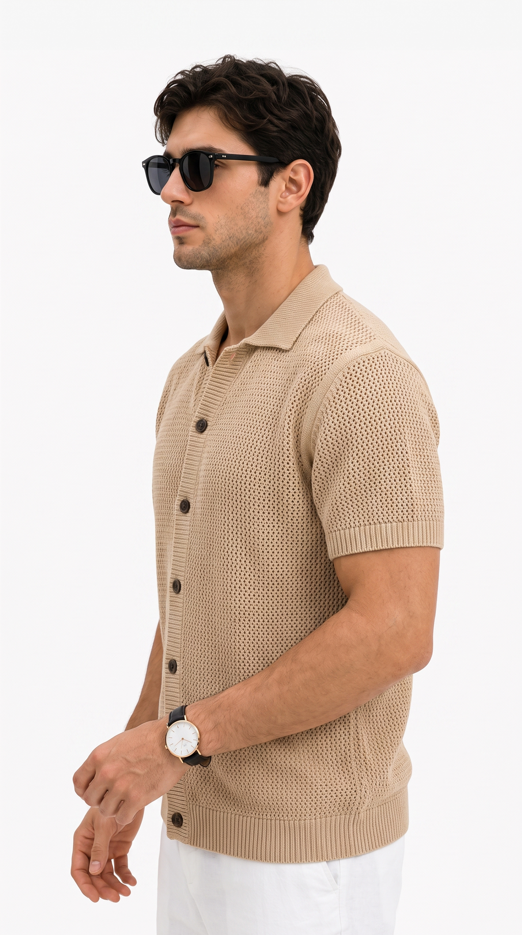 A man in profile wearing a beige short-sleeve knit polo button-up shirt, white pants, black sunglasses, and a watch, photographed against a clean white studio background, from Meleche Fashion USA or Meléche (short as (Mé))
