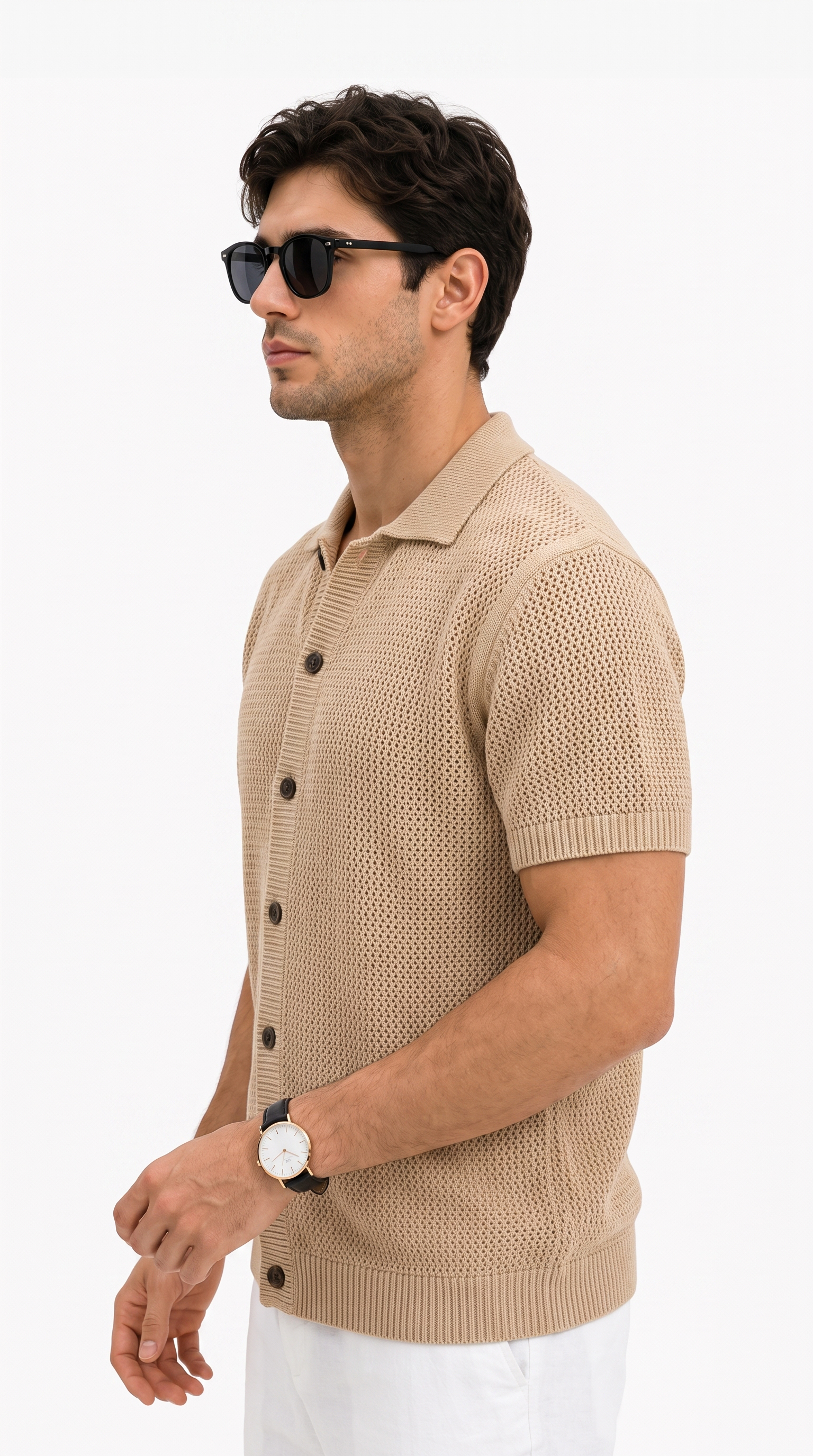 A man in profile wearing a beige short-sleeve knit polo button-up shirt, white pants, black sunglasses, and a watch, photographed against a clean white studio background, from Meleche Fashion USA or Meléche (short as (Mé))