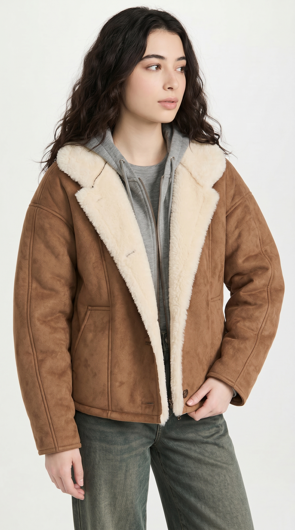 Person wearing a brown shearling jacket on a white background from Meleche USA or Meléche (short as (Mé))
