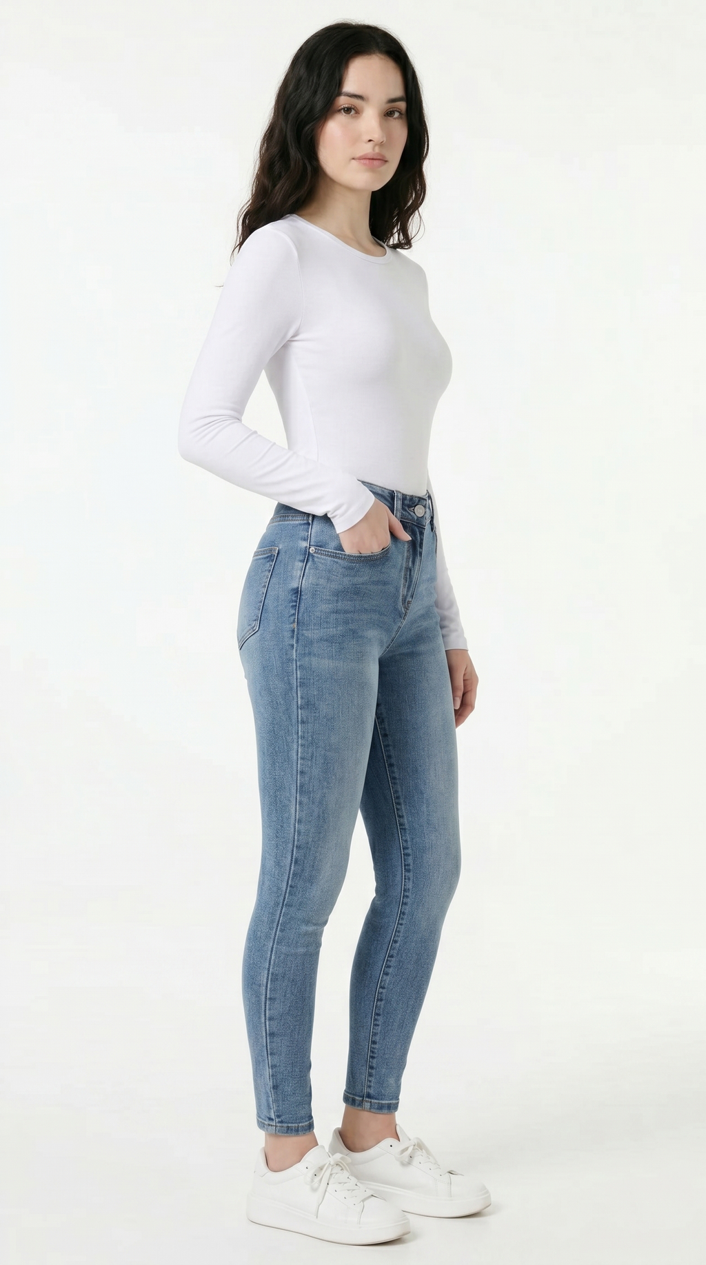 Woman wearing a white long-sleeve top and light blue jeans on a white background, High Stretch Sexy Skinny jeans from Meleche Fashion USA or Meléche (short as (Mé))