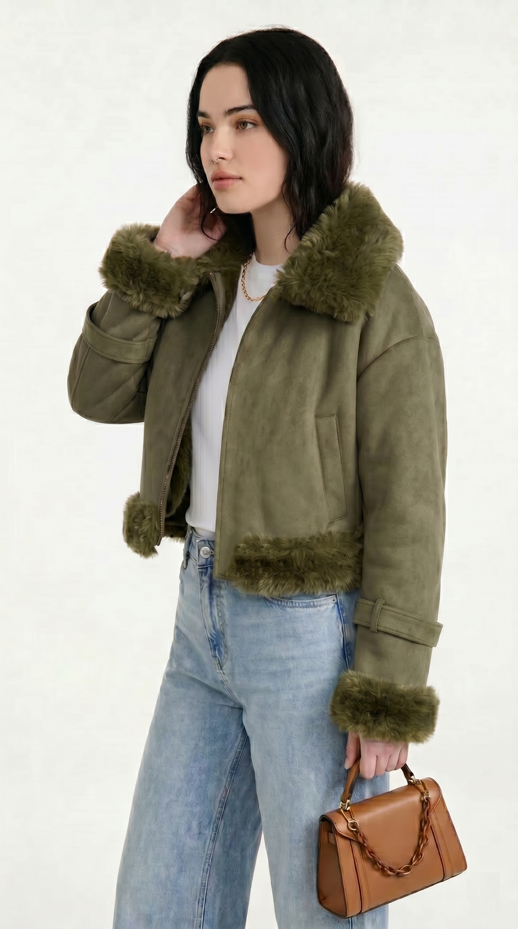 Woman wearing a green jacket with fur trim, holding a brown handbag on a white background from Meleche or Meléche USA (short as (Mé))