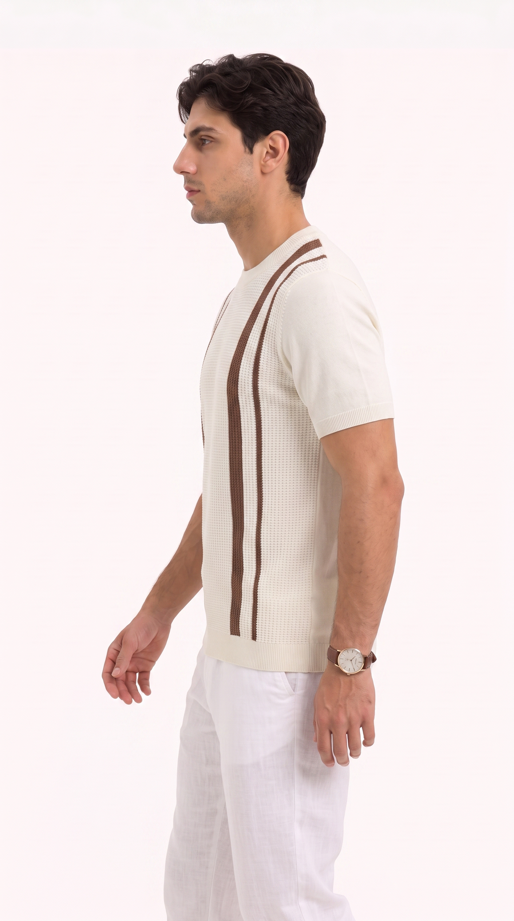 A man in profile wearing a cream ribbed short-sleeve knit sweater with two vertical brown stripes on the chest, paired with white trousers, against a plain white studio background, from Meleche Fashion USA or Meléche (short as (Mé))