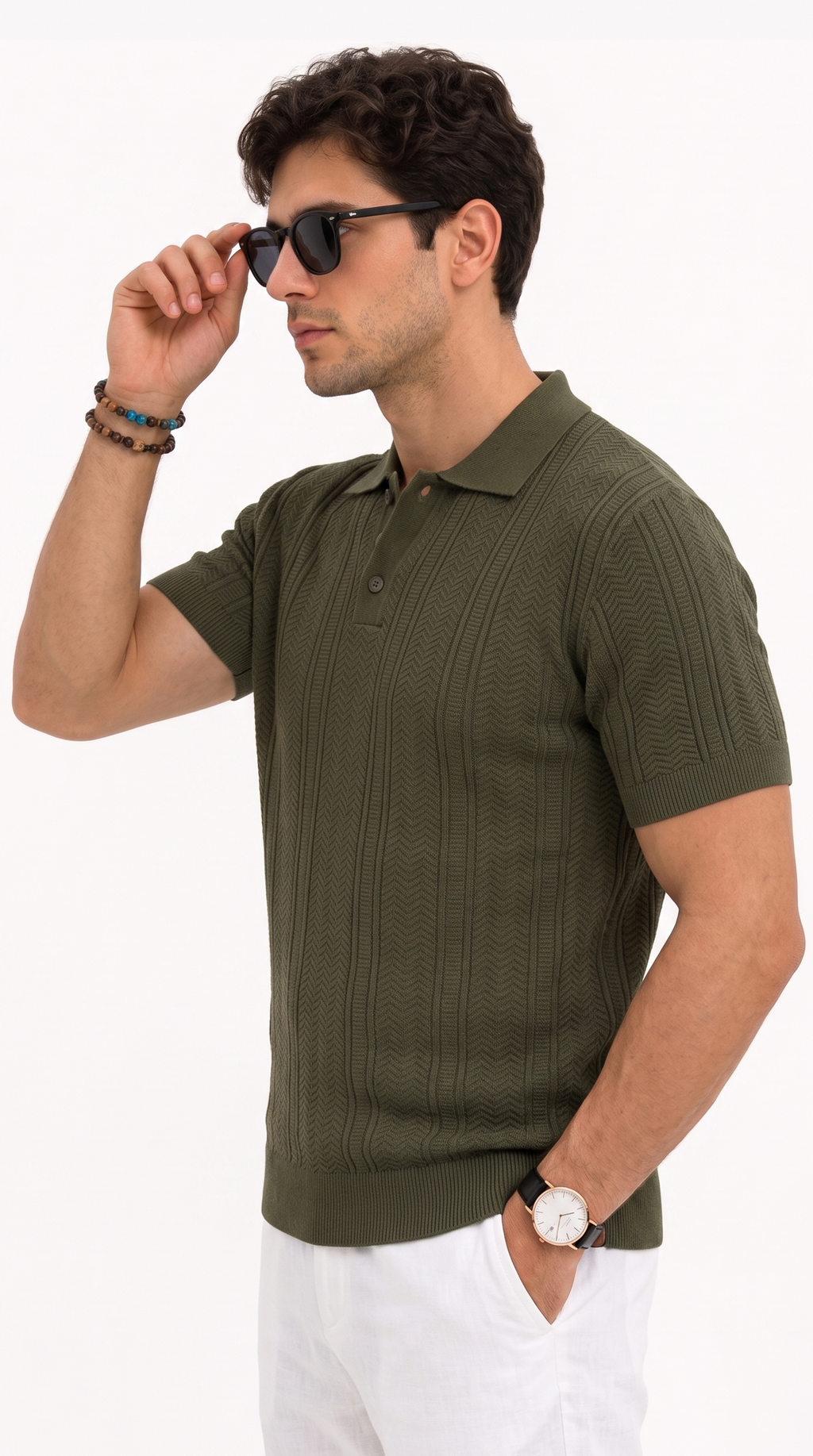 A man wearing an olive green short-sleeve polo shirt with a vertical ribbed texture, styled with white pants, sunglasses, and bracelets, against a plain white background, from Meleche Fashion USA or Meléche (short as (Mé))