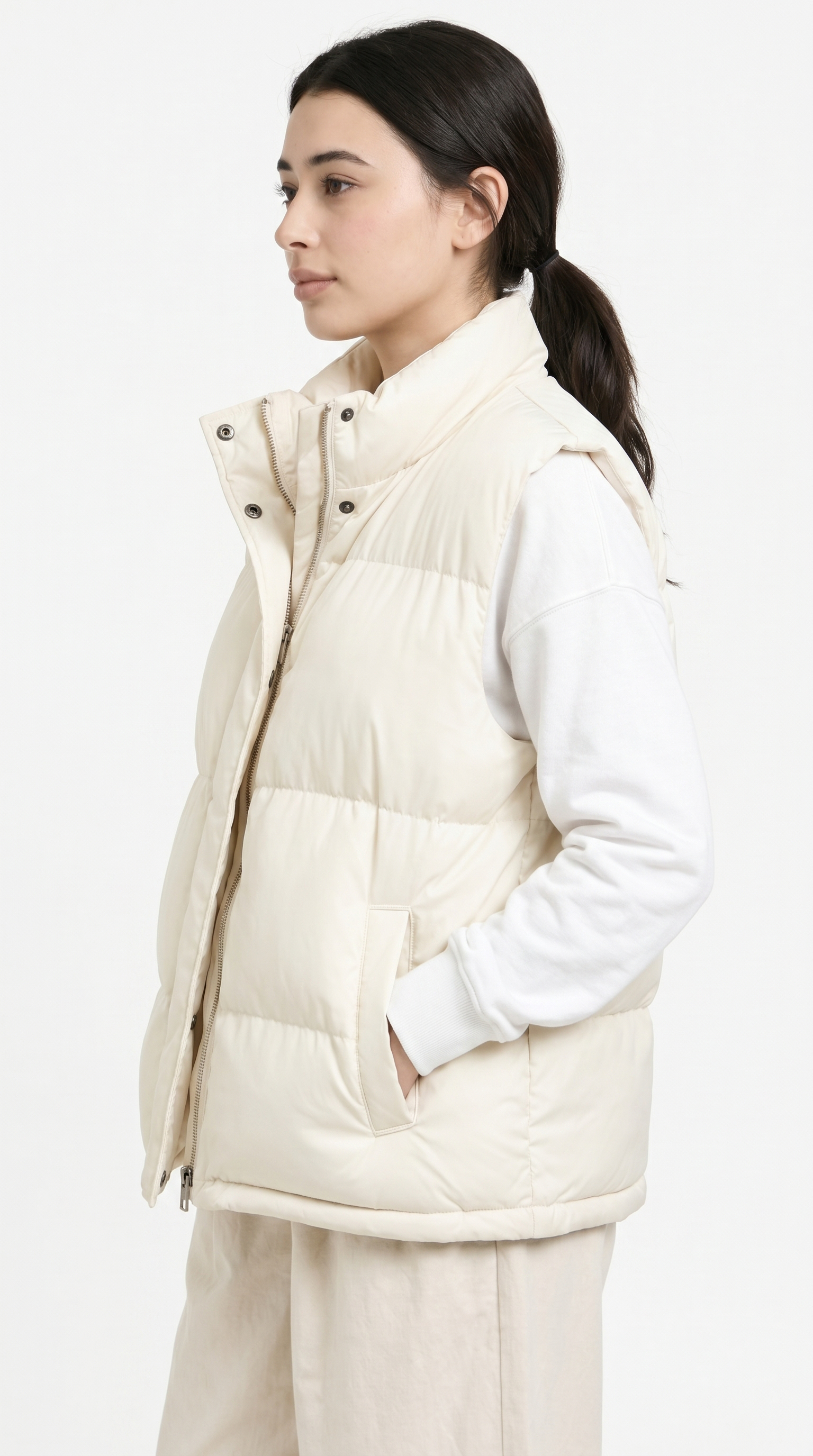 girl from side view wearing a white puffer vest over a white shirt on a white background from Meleche Fashion USA or Meléche (short as (Mé))
