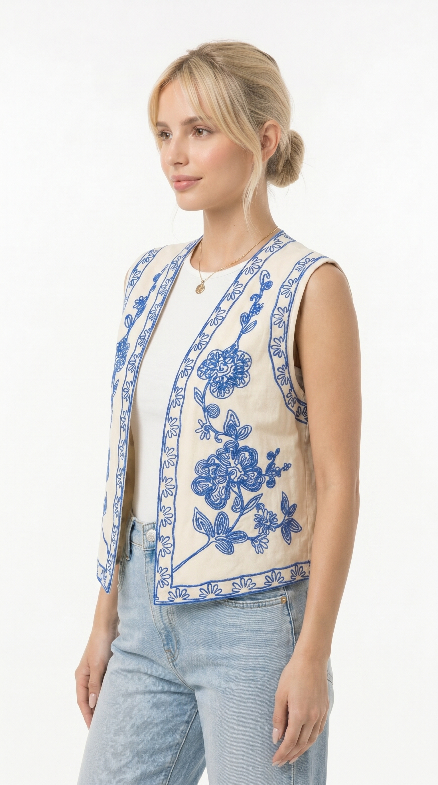 Woman wearing a sleeveless floral embroidered top on a white background from Meleche Fashion USA or Meléche (short as (Mé))