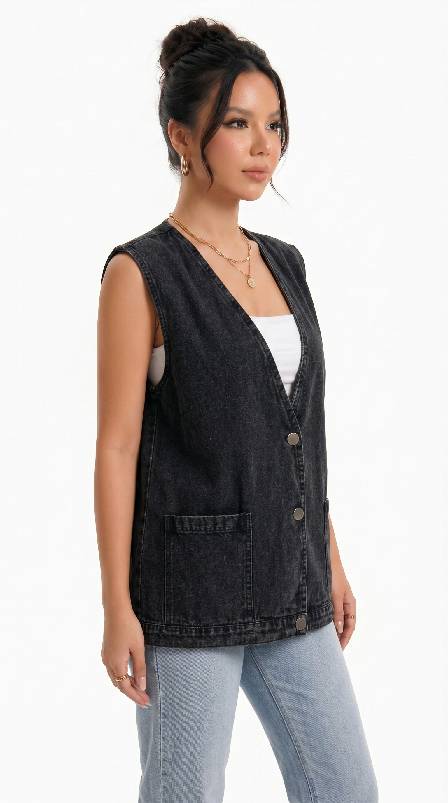 Woman wearing a black sleeveless denim vest over a white top and light blue jeans on a white background from Meleche Fashion USA or Meléche (short as (Mé))